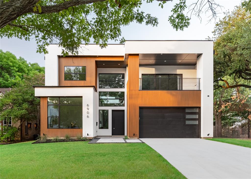 Located in the highly sought-after C Streets and zoned to the acclaimed Lakewood Elementary, this stunning new construction by Avant Group offers 4,725 square feet of modern luxury just minutes from White Rock Lake, Lakewood Village, and Dallas’ premier dining and retail. Thoughtfully designed with natural elements and bold architectural features, this 5-bedroom, 5-bath residence balances everyday functionality with elevated living. Soaring ceilings, white oak hardwood floors, and a spacious open-concept layout seamlessly connect the kitchen, dining, and family rooms.
The gourmet kitchen is a showpiece, featuring hand-built cabinetry, a huge quartz island, WOLF® dual fuel range, 48-inch built-in Café® refrigerator, dry bar with LED-lit floating shelves and wine cooler, plus a walk-in pantry with generous storage and garage pass-through. Downstairs, the luxurious primary suite stuns with a soaring vaulted ceiling, sliding glass doors leading to backyard, and spa-like bathroom complete with floating vanity, a vessel tub, oversized rainfall shower, and a custom walk-in closet. Also on the main level: a versatile guest suite or private office with ensuite bath and a large laundry room. Upstairs, a game room with wet bar opens to a spacious covered veranda, while three additional bedrooms each feature ensuite baths and walk-in closets. Built with performance and peace of mind in mind, this home includes a Control4® Smart Home system, CAT-6E pre-wiring, foam insulation, dual tankless water heaters, piered-slab foundation, and a Maverick® 1-2-10 Builder’s Warranty. A masterful blend of design, technology, and location—6906 Clayton Ave delivers refined living in one of Dallas’ most desirable neighborhoods.