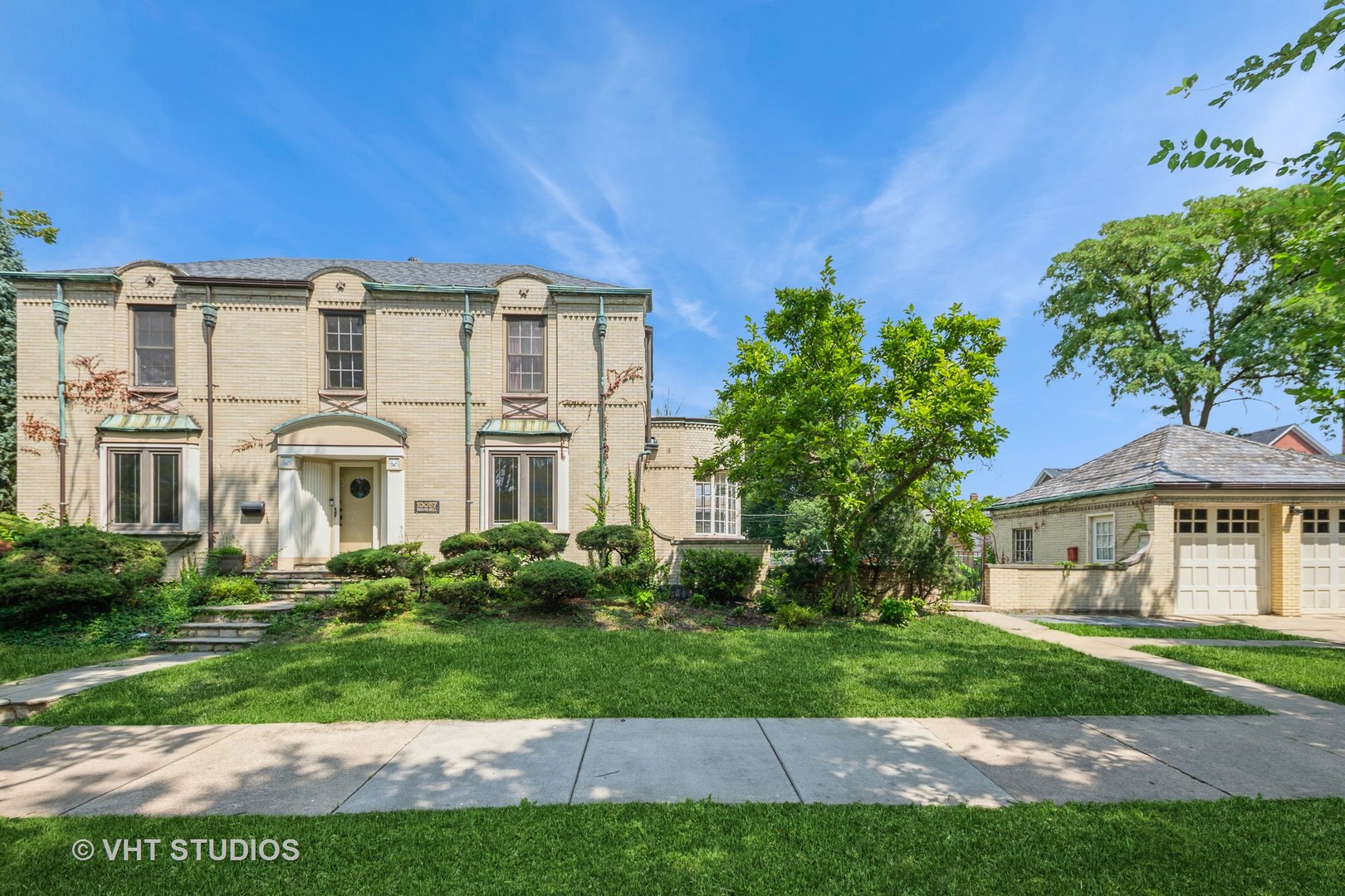 Cool Art Deco Colonial in a premium Beverly location. Has great interior & exterior character.  Corner brick house and matching brick garage with slate roof and decorative copper gutters & copper window overlays. The main has a large formal living room with bay window, stone fireplace bay window area. Generous sized formal dining room each with marble ledged windows, hardwood floors and oak-lined bookshelves. Curved sun room overlooks the yard.  The kitchen has been updated with granite countertops, stainless steel appliances and undermount sink. Blend of original cabinets, garden window and walk in pantry area. Main level half bath. Curve corners. The second floor features hardwood floors and 3 bedrooms. A huge master bedroom with dual closets and en suite shared full bath with heated floor. Second bedroom has a walk out sitting porch that is overlooking the backyard.  Finished basement features family room with a fireplace and a 4th bedroom or office. There is a modern full bathroom in the basement. Utility room and a separate laundry room with access to the yard. Wide Side drive leads to double door brick garage. Nice builtins. Less than one block to Sutherland Elementary and close to parochial schools. Walk to the Metra train station and nearby parks. Exterior has stone front walkway & porch. Ready for your vision and ideas. Immediate possession