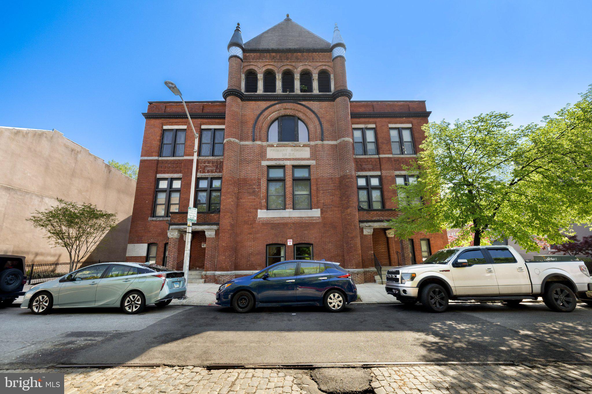 What a privilege to live in this historic circa 1892 late Victorian-era stunning architecture! The 2006 renovation/restoration project created a gorgeously unique residential opportunity to live in this beautiful 19th-century former school ("Public School #25 or "Captain Henry Fleete School") with all the conveniences of the 21st-century!  This contemporary 1 bedroom condo is impressive from the first step over the threshold with its soaring nearly 2-story ceiling that imbues every corner with abundant natural light! Handsome echoes of yesteryear are present in the hear pine floor in the well-appointed kitchen that offers granite countertops, 42-inch white cabinetry and stainless steel appliances.  The spacious dining/living room combination and its handsome solid oak floor is bathed in light from the huge southerly-facing windows! Similarly, the bright bedroom is spacious enough to host a desk/office area and generous walk-in closet. The full bath offers a ceramic tiled tub/shower combination and vanity. Experience lifestyle ease while being located right in the middle of Fells Point! While inside your quiet urban retreat, plan your next Baltimore adventure and enjoy the best that Baltimore has to offer right outside your door!
