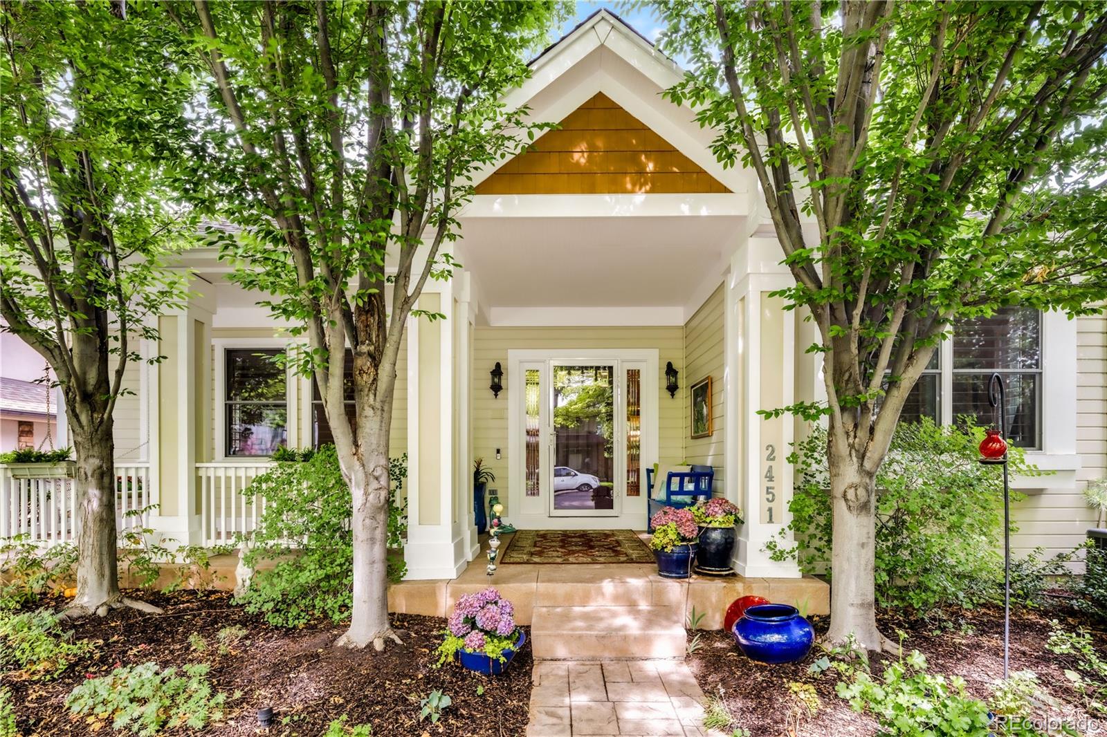 Welcome to this Observatory Park home, where classic Craftsman details meet a thoughtfully designed floor plan.  The main level features a front-to-back flow that connects the living spaces. Hardwood floors guide you past a dining room with a built-in banquet and a double-sided fireplace shared with the family room. Large windows frame the surrounding greenery, bringing sunshine into every corner. The kitchen is equipped with a walk-in pantry, eat-at island, and premium Viking appliances, all purchased in 2025, including refrigerator, double wall ovens and drawer microwave. A main-floor office with a closet and an adjacent full bath with a walk-in shower functions well as a main-floor bedroom or guest suite.Upstairs, the primary suite features a remodeled five-piece bath with a steam shower and soaking tub. Two additional bedrooms include walk-in closets and a shared bath. The finished basement adds living space with a wet bar, storage, a full bath, and two conforming bedrooms ideal for a media room or gym.The indoor living areas open directly to a private backyard patio. This quiet outdoor space features a meticulously planned, low-maintenance garden, creating a peaceful retreat that requires minimal upkeep. The detached two-car garage includes a finished heated studio space, perfect for a private home office or fitness room. The home features premium integrated audio throughout, including high-end Focal in-ceiling speakers in the family room, primary suite, and shower, alongside custom-zoned outdoor speakers delivering high-fidelity sound to both the dining patio and the garden. This home has been thoroughly maintained and updated, including a 2023 furnace, a new 2025 HVAC system, two 50-gallon hot water heaters, wired for future whole-home control system, an App-controlled Rachio sprinkler system, lower-level security screens, and a 50-year hail-resistant roof. This property sits just blocks from Denver University, local parks, and the historic Observatory.