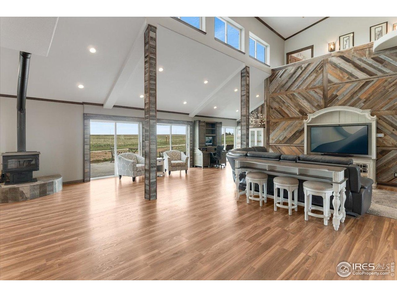 PRICED BELOW MARKET VALUE TO SELL NOW! Must see in person to fully appreciate this gorgeous 6 bedroom, 4 bathroom Barndominiom with fenced- in acreage! This impressive two-story home features an open and well-planned layout with elegant interiors, high ceilings, and beautiful Black Hills reclaimed wood throughout. The spacious gourmet kitchen boasts high-end appliances, an oversized island with seating, counter prep space, and custom cabinetry for storage. You will love the main floor with its 25-foot vaulted ceilings, wood burning stove, large windows and glass sliding doors allowing an abundance of natural light. The main floor primary bedroom offers plenty of space to relax and unwind, an includes a large walk-in closet, sitting room, an en-suite luxury bathroom with dual sinks, soaking tub, and a separate shower with dual rainfall shower-heads. Built in 2016, this solid built home utilizes ICF insulated walls and will easily withstand the Colorado extreme wind and weather. Energy efficient appliances, LED lighting, on- demand water heater, 700 - foot deep well, plus a 5- ton ac unit. Attached 3 -car garage/workshop and driveway parking provide ample space for all of your vehicles and toys. Outside you will find a Full RV Hookup that is adjacent to the house, complete with sewer, water, and electric, 8 acres of land fenced and gated, easy access driveway using recycled crushed concrete, a huge 10,000 square foot concrete pad with floor drainage, complete with a brand new storage building and ready for your future workshop, greenhouse , raised garden beds or barn to be added when you are ready! Resting on just over 20 acres of picturesque views you will enjoy the huge covered front porch, sprawling back patio to take in both breathtaking sunrises and peaceful sunsets each and every day! Need more land? Don't wait - The adjacent 35 acres is also currently available! Schedule today to visit this property tomorrow!