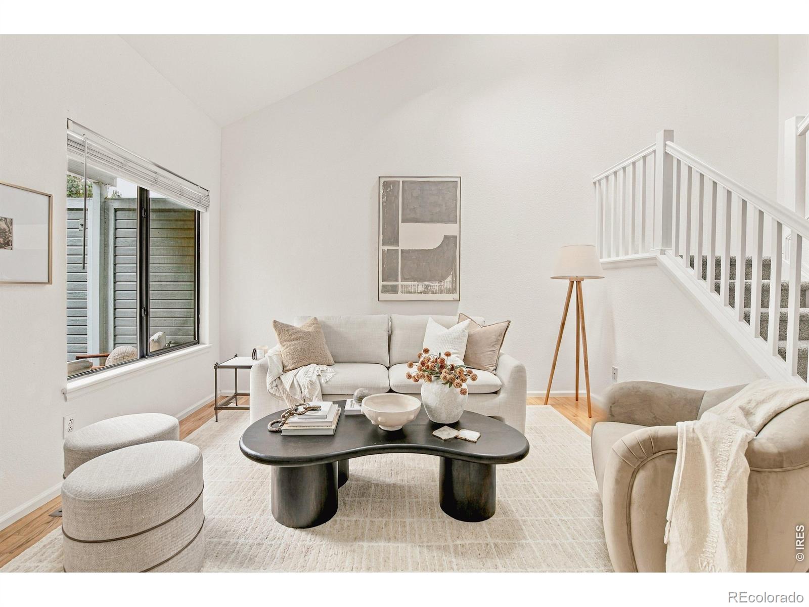 Sun-filled and thoughtfully appointed, this end-unit townhome in Louisville's Wildflower Condos pairs a spacious layout with inviting outdoor spaces. A welcoming front porch introduces the main level, where hardwood floors, vaulted ceilings and large windows create an airy sense of scale. The living area opens to the dining space, while the stylish kitchen features granite countertops, stainless steel appliances and a breakfast bar with seating. Upstairs, the vaulted primary bedroom offers a walk-in closet, joined by a versatile secondary bedroom and a full bath. New carpeting adds a fresh finish, while the finished basement expands the townhome with a recreation room/3rd bedroom, 3/4 bath and laundry area. A fenced patio extends the living space outdoors, creating a private setting for everyday enjoyment. This well-cared for home offers an oversized attached two-car garage and a refined take on low-maintenance living. Positioned in a coveted Louisville location close to the recently renovated Louisville Rec Center, parks, trails, and charming shops, restaurants, and entertainment of Downtown Louisville.