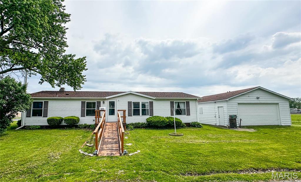 Your next home is waiting...full of space, updates, and charm!  This 3 bedroom, 2 bathroom manufactured home sits on a corner lot on a dead end street, featuring a desirable divided floor plan with a spacious primary suit.  Enjoy both a living room and a family room with a cozy fireplace-perfect for gatherings or quiet nights in.  The detached 2 car garage adds extra storage and parking space, while recent updates bring peace of mind: HVAC (2022), Roof and Water Heater (2021), and some newer flooring.  A great blend of space, function, and value!