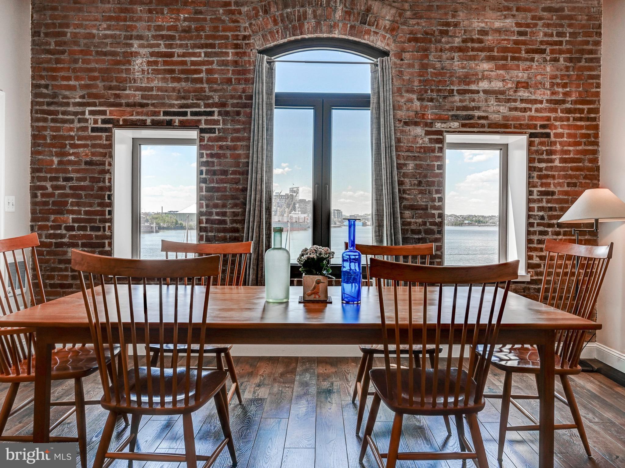 Fantastic two-bedroom, two-bath loft condo with direct water views in historic Fells Point. This fully renovated two-story residence offers a spacious and versatile layout, with one bedroom on the main level and another on the upper level.The updated kitchen features granite countertops and top-of-the-line appliances, opening to a bright living space with hardwood floors throughout the main level. The large primary suite includes a walk-in closet and a spa-like bath. Ideally situated in one of the best locations in Fells Point, enjoy easy access to the neighborhood’s vibrant restaurants, shops, and waterfront just steps from your door.