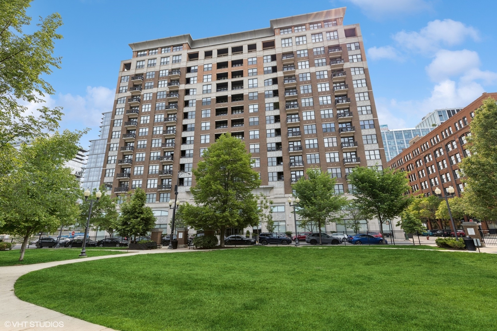 STUNNING, updated SE corner 3 bed/2 bath at the unmatched Parc Chestnut with City views! Walk into your 1800 sq ft home featuring full entry foyer that opens into a sundrenched open floor plan. MASSIVE kitchen featuring a 12' island with Quartz countertops, newer Jennair stainless steel appliances, Ann Sacks backsplash and recessed lighting. Refinished hardwood floors throughout the MASSIVE 37' living/dining - perfect for entertaining. CUSTOM built-in bar in the dining area that accommodates a full size table with SWEEPING windows flooded with sunlight and skyline views. Balcony off dining room. Electronic solar shades, Closetworks and Lightology fixtures throughout. Large storage closet on same floor. 2 car tandem garage space INCLUDED in price. Full amenity building: 24 hr. doorman, Hospitality Room, Fitness Room, Business Center, Private Park,  2 Terrace sun decks, Dog Run, Bicycle Storage, Dry-Cleaning Service & On-Site Management. Steps to Brown line, shops, restaurants and all the city has to offer!