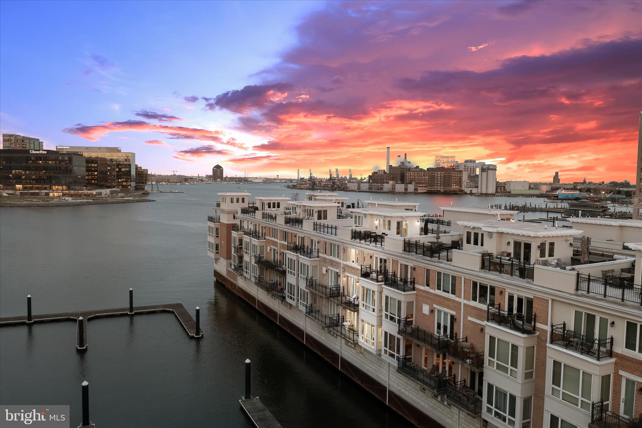 FOR OPEN HOUSE ACCESS -- Please call or text Julie at 410-303-3281 or Rachael at 443-694-7858 for gate code!!Experience elevated waterfront living in this fully renovated five-level smart home overlooking Baltimore’s harbor and skyline, complete with a private elevator and rooftop deck. Designed for both luxury and ease, the home blends striking design, marble finishes, heated floors, custom closets, designer lighting, and bold architectural details, with a fully integrated smart system that adapts to your lifestyle.  Set the tone for your day with personalized morning and evening routines, automated lighting, music, climate, and window shades that adjust seamlessly at the touch of a button or voice command. From Lutron lighting and smart locks to whole-home Sonos, mesh WiFi, and touchless fixtures, every detail is built for effortless living.  With a chef’s kitchen, spa-inspired bathrooms, custom wet bar, EV charging, and a smart, upgraded garage, this home offers a rare combination of thoughtful design, advanced technology, and prime waterfront views.  Nestled within an exclusive gated community, this exceptional residence showcases sweeping harbor views and an unparalleled blend of elegance and comfort. A grand double wrought iron door entry welcomes you into a stunning foyer adorned with marble flooring, intricate box and picture molding, and seamless access to both a two-car garage and a private en-suite bedroom featuring sophisticated fixtures and designer finishes. The main living level is thoughtfully designed with an open floor plan, showcasing rich oak flooring and soaring ceilings that create a warm, inviting ambiance throughout. The living room is anchored by a gas fireplace, complemented by custom-built-in bookcases and access to one of several private balconies. The dining area is bathed in natural light and enhanced by refined millwork, integrated whole-home audio, and picturesque harbor views. At the heart of the home, the gourmet kitchen is a chef’s dream, featuring a spacious center island with breakfast bar, 42-inch cabinetry, quartz countertops, stainless steel appliances, a butler’s bar, and a built-in buffet with open shelving, perfect for both everyday living and elegant entertaining. Retreat to the luxurious primary suite, complete with a generous walk-in closet, sitting area, private balcony access, and a custom-built-in wardrobe. The spa-inspired en-suite bath offers a jetted soaking tub, an arabesque-tiled walk-in shower, heated floors, dual vanities, and a private water closet. The penthouse level provides a versatile open space ideal for a home office, highlighted by a gas fireplace, along with two additional bedrooms, one with balcony access, and a well-appointed hall bath. Additional features include a private elevator, fully renovated bathrooms, and California Closet systems throughout for optimal organization. Enjoy direct water access with private docks, perfect for boating enthusiasts. Ideally located with convenient access to major commuter routes, including I-95, I-295, and I-83, this home offers effortless travel to Washington, D.C., New York City, and Baltimore’s most iconic destinations, including M&T Bank Stadium, Camden Yards, the National Aquarium, and beyond. This is waterfront luxury redefined.