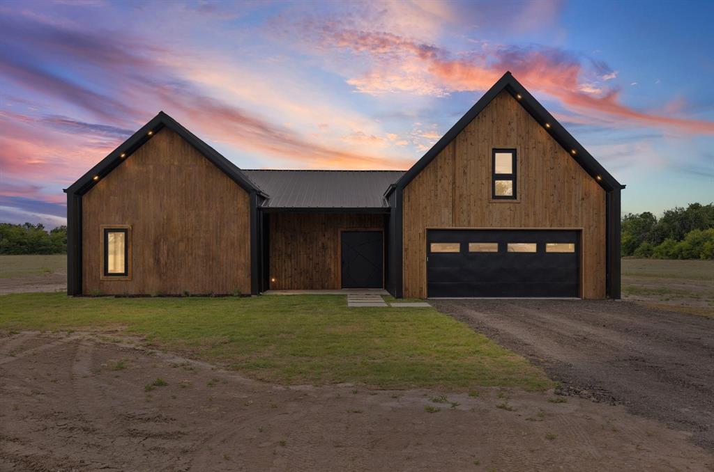 NEW BUILD - READY TO ENJOY is this very spacious 4 Bedroom 4 Bath custom built barndominium with 9 acres located on a peaceful county road. This home features special builders touches from front to back with custom built entry and gates, micro cement flooring, custom cabinets, quartz countertops and much more!
 As you enter the extra wide vault type front door you find wide accessible hall leading to the large living area with cathedral ceilings, stained trim  and a dry bar. The custom kitchen features include an island, beautiful cabinets, quartz countertops and huge (6.5x13) walk-in pantry that has custom shelves and a sink. The large custom built windows along back of the dining area allows you to enjoy the natural lighting. Outside you will find a large covered entertainment area that could feature an outdoor kitchen, table, pool, hot tub and providing plenty of space for all if desired. The large (15x16) primary bedroom has custom bath, shower, quartz countertops and a walk-in closet with custom shelves and shoe rack. The second large bedroom also has a custom closet. The other two bedrooms have their own bath with shower. Upstairs you will find a large (28x18) game room with bamboo flooring and providing plenty of space for your imagination. Added to the floorpan as a bonus is a custom built (8x8) safe room. (Not on floorpan)
This home was designed and built with ownership in mind with spray foam insulation, easy upkeep features, all plumbing downstairs, large rooms, custom touches throughout, gated entry and about anything you could ask for in a new home. The 9 acres offers plenty of space with tree lined boundaries for extra privacy. There is plenty of room for a shop, barn, garden and animals to enjoy your NEW home with that peaceful country life. 
This amazing home is also avaiable on 3 or 6 acres to fit the buyers needs.