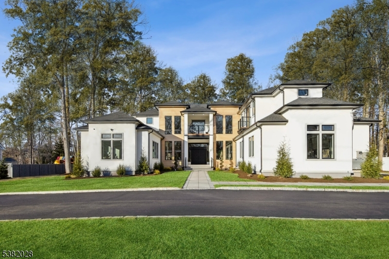 Nestled on almost an acre, this NEW and CUSTOM luxury estate is the epitome of luxury living. Completed in 2025, this breathtaking masterpiece offers 15,000 square feet of exquisitely designed living space, featuring 17 rooms, including 7 ensuite bedrooms and 8.1 bathrooms. The exterior impresses with its seamless blend of stucco and aluminum planks, oversized Pella Lifestyle windows and multiple balconies. The property includes a circular driveway, a three-car garage with epoxy floors and custom Mahogany doors, and beautifully landscaped grounds, complete with a covered paver patio and outdoor kitchen. Inside, a soaring 22-foot foyer welcomes you. You are sure to be impressed by the 11-foot ceilings, 5" white oak floors, and a state-of-the-art Chef's kitchen with Calacatta quartz countertops, custom cabinetry, top-of-the-line GE Monogram appliances, large center island, and "hidden" walk-in pantry. The primary suite offers a private terrace with a spa-like bath & custom walk-in closets. All bedrooms include ensuite baths and WIC's. The fully finished walkout basement is designed for entertainment and relaxation, boasting a massive recreation room with wet bar, home theater, exercise room and sauna. Additional features include a Generac 40kW whole-house generator, 5-zone HVAC, NEST thermostats, LED lighting, sprinklers and a huge yard. With its breathtaking design, high-end finishes, this one-of-a-kind estate invites you to experience a life of refined luxury beyond compare.