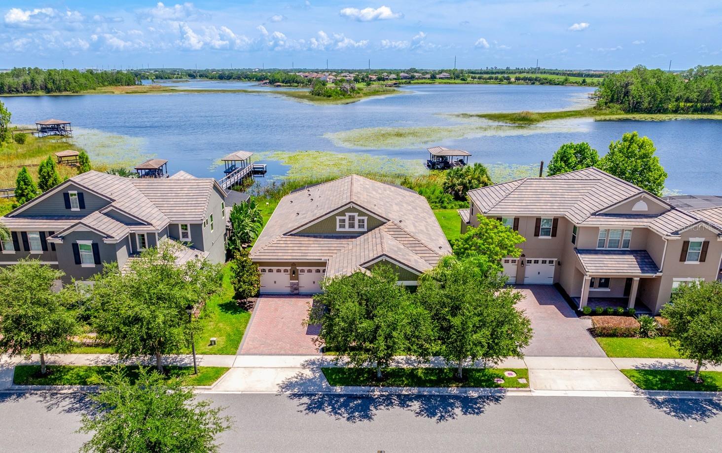 Under contract-accepting backup offers. Lakefront property, private pool/hot tub, outdoor living space, and Disney fireworks view! **Welcome to LAKEFRONT LIVING at its finest in the sought-after Waterleigh community of Winter Garden! This stunning 4-bedroom, 3.5-bath single story POOL HOME sits along the shores of SKIABLE HICKORYNUT LAKE, offering panoramic WATER VIEWS, nightly DISNEY FIREWORKS, and a lifestyle that's equal parts relaxation and recreation. From the moment you arrive, the CURB APPEAL impresses with a spacious 3-CAR GARAGE, manicured landscaping, and an inviting covered front porch. Inside, modern design meets everyday comfort with WOOD LOOK TILE throughout the main living areas and plush BRAND NEW CARPET (2025) in all the bedrooms. FRESH INTERIOR & EXTERIOR PAINT (2025), along with a freshly power-washed exterior, porch, and driveway, make this home move-in ready! The heart of this home is a bright, OPEN CONCEPT LIVING SPACE where the kitchen, dining, and living areas flow seamlessly together. Large windows frame the LAKE VIEWS, while a tray ceiling adds architectural interest, defining the space. The kitchen is a true showpiece – timeless yet current – with QUARTZ COUNTERTOPS, STAINLESS STEEL APPLIANCES, a BUILT-IN OVEN, rich cabinetry, coordinating island with breakfast bar, complementary backsplash, and generous pantry storage. Step outside and into your own lakefront retreat – a fully SCREENED lanai, HEATED SALTWATER POOL, and SPA offer the ultimate in indoor-outdoor living. Whether you are entertaining or unwinding, this is the kind of backyard dreams are made of. And yes—you can build your own private dock to launch weekends on the water! Your OWNER’S SUITE is tucked privately at the back of the home and offers spectacular lake views, a spa-like en-suite bath with dual sinks, soaking tub, FRAMELESS GLASS SHOWER (updated 2025), and a spacious WALK-IN CLOSET. Three additional bedrooms offer flexible living, including one with an en-suite bath—ideal for guests or multi-generational living. A mudroom/storage area, convenient half bath, large laundry room, and ample storage complete the thoughtful floor plan. Additional features include double-pane windows, upgraded finishes, and a roof that’s been recently cleaned and maintenanced (2025). Waterleigh is known for its RESORT STYLE AMENITIES: community pool, clubhouse, mini golf, playgrounds, walking trails, and epic seasonal events—Halloween and Christmas are not to be missed! Enjoy TOP-RATED SCHOOLS and the convenience of a grocery store right in the community – with easy access to dining, shopping, parks, and major roadways like SR 429, Avalon Road, and US 192. Built in 2018 and beautifully maintained, this home offers a refined, laid-back lifestyle with every detail designed for your comfort and enjoyment. Plus a front-row seat to some of Central Florida’s best sunsets. Schedule your private tour today and make lakeside living your reality!