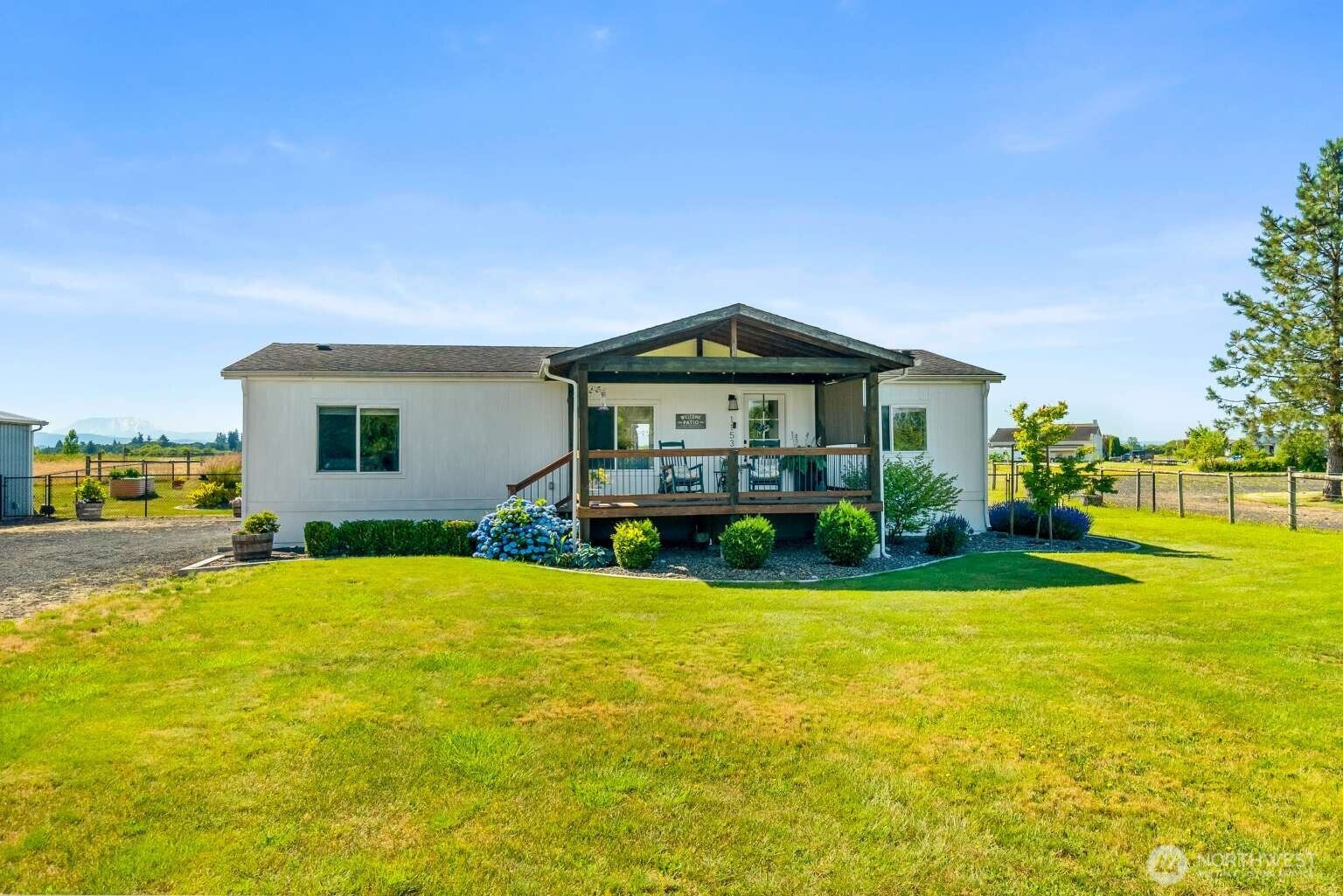 Enjoy country living on 3.01 acres with breathtaking views of Mt. St. Helen and Mt. Rainer. This 3-bed, 2-bath manufactured home offers 1,296 sq. ft. of comfortable living space and thoughtful updates throughout. New vinyl flooring and updated carpet provide a fresh feel, while the primary suite features a beautifully tiled walk-in shower. The fenced backyard is perfect for pets or outdoor enjoyment. A detached garage/shop offers great space for parking, projects, or storage, and outside RV parking adds flexibility for all your toys. Built in 1995, this property combines privacy, functionality, and Iconic Pacific Northwest scenery. A rare opportunity to own usable acreage with unforgettable views