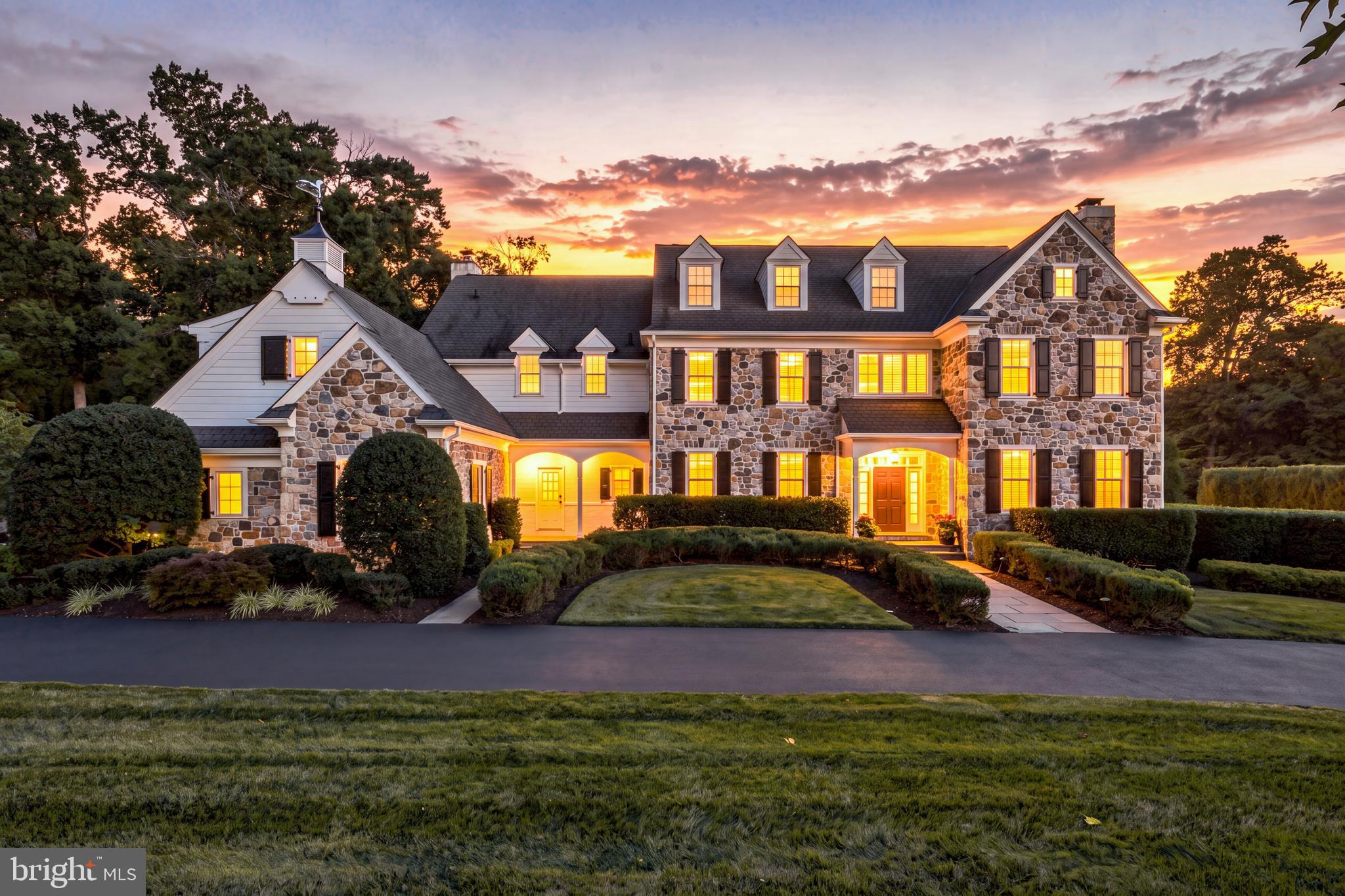 Beautiful interior! Situated in the coveted "White Horse" community, 72 Farrier Lane offers exceptional curb appeal with its striking stone exterior, black shutters, white Hardie Board siding, and a circular driveway. Custom built by award-winning Nolen Company Builders, this stately colonial delivers a seamless blend of historic architectural inspiration and modern luxury. Renowned for superior craftsmanship, Nolen homes are celebrated for their extensive custom wood moldings, raised-panel wainscoting, arched doorways, high ceilings, and rich finishes throughout.A grand front-to-back foyer with a turned staircase, impressive moldings, and hardwood floors sets an immediate tone of elegance, offering French doors that open directly to the private rear new deck with peaceful pastoral views overlooking the rear yard. Designed for both festive hosting and effortless everyday living, the main level features a light-filled formal living room with a gas fireplace and plantation shutters, which are found throughout. A show-stopping dining room is adorned with gorgeous grasscloth wallpaper and light fixtures, paneled curtains, and an adjoining butler’s pantry. Off the foyer is an executive office featuring rich wood-tone built-ins, a gas fireplace, built-in window seat, and glass doors. A formal powder room with a private vestibule is conveniently located nearby.At the heart of the home is a stunning kitchen featuring white cabinetry, quartz countertops, a large center island that seats four, white subway tile backsplash, top-tier appliances including a Sub-Zero side-by-side refrigerator/freezer and a double Wolf oven, a command station, and a large walk-in pantry. The kitchen opens into a beautiful sun-lit breakfast room with a striking vaulted, wood-paneled ceiling with exposed beams. A sliding door leads directly out to the deck. A large, step-down great room offers a warm gathering space anchored by a wood-burning fireplace and high arched beamed ceilings. A second powder room, back staircase, and a  mudroom with built-in cubbies, coat closet, and access to the attached 3-car garage complete this level.Upstairs, the expansive primary suite serves as a luxurious retreat, featuring a sitting room, dual custom-fitted walk-in closets, and an en-suite bath with dual vanities, soaking tub, and a large tile shower. Down the elegant hallway with arched doorways and wood floors are four additional spacious bedrooms—each with its own en-suite bathroom and significant closet space, perfect for family and out-of-town guests. A built-in workstation with dual desks offers a great space for homework with plenty of storage. A large laundry room with a sink and cabinets as well as a nearby linen closet complete this floor. A finished third floor offers versatile space for a cozy loft, additional bedroom, or storage.The finished walk-out lower level expands your gathering options with a second family room featuring a projection screen and surround sound, an exercise room, a full bath, and a bonus play area. Outdoors, enjoy a private rear yard featuring an expansive deck that looks out over manicured lawns, open green space, and a lush, mature tree canopy with pastoral views. Enjoy unbeatable convenience to Newtown Square’s Ellis Preserve and Whole Foods shopping center, downtown Wayne, Paoli, Bryn Mawr. Located in Marple Newtown School District, close to top private schools - Episcopal Academy, Agnes Irwin, Haverford, Notre Dame, and Malvern Prep. Easy access to local country clubs, major highways, and the Paoli Train Station makes commuting to Philly and NYC a breeze.This Nolen-built home offers the perfect harmony of stately traditional architecture and peaceful surroundings within a desirable neighborhood of three cul-de-sac streets—making 72 Farrier Lane a wonderful place to call home.
