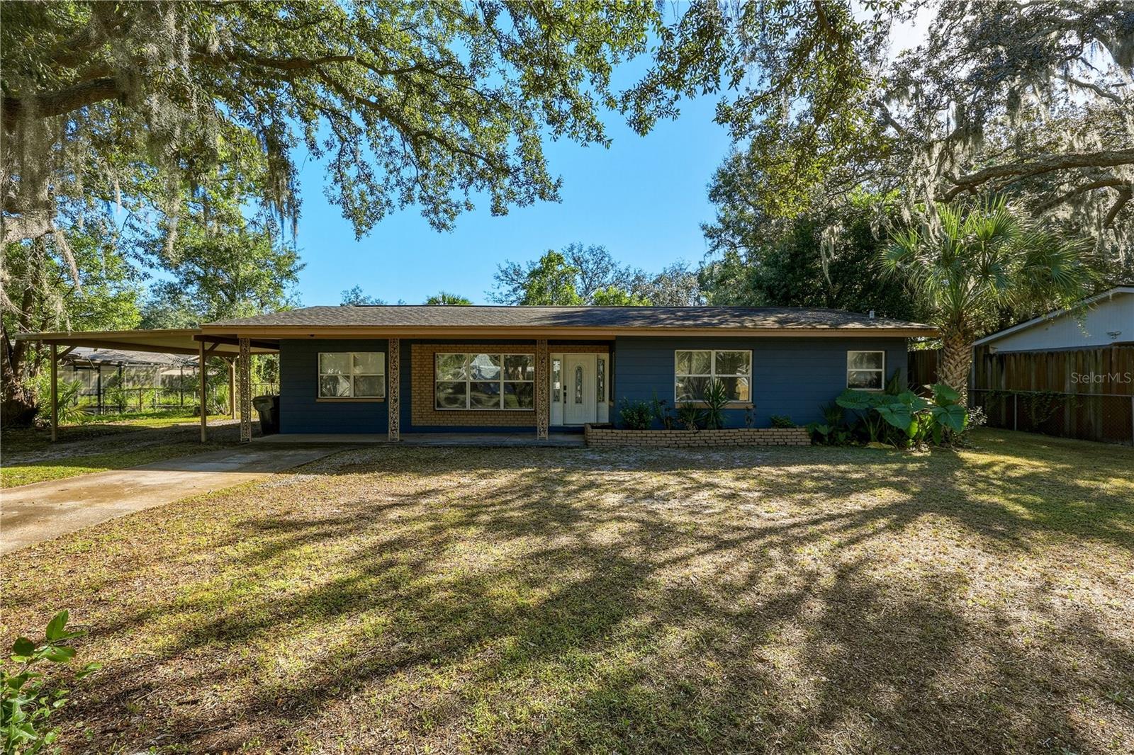 Welcome to this charming 3-bedroom, 2-bathroom mid-century ranch-style home in the highly desirable Herchel Heights neighborhood of Terrace! Full of character and warmth, this inviting home features a covered front porch, beautiful mature oak trees, and a spacious carport. Inside, enjoy an open floor plan with soaring ceilings, original polished terrazzo flooring, wood-look tile, and a stunning exposed wood ceiling that creates a beautiful focal point in the great room. French doors lead to the backyard, creating a seamless flow for indoor-outdoor living. Step outside to enjoy the fully fenced backyard with a patio perfect for entertaining, relaxing, or enjoying Florida's beautiful weather, plus a storage shed for added convenience. Ideally situated near the Hillsborough River, this home offers easy access to parks, scenic boardwalks, fishing, a boat ramp, schools, shopping, dining, and Busch Gardens. Conveniently located near I-75, I-275, and I-4, commuting to Downtown Tampa and traveling throughout Central Florida is a breeze. Whether you're a first-time homebuyer or looking for a home with timeless charm and character, this  Terrace gem is a must-see!