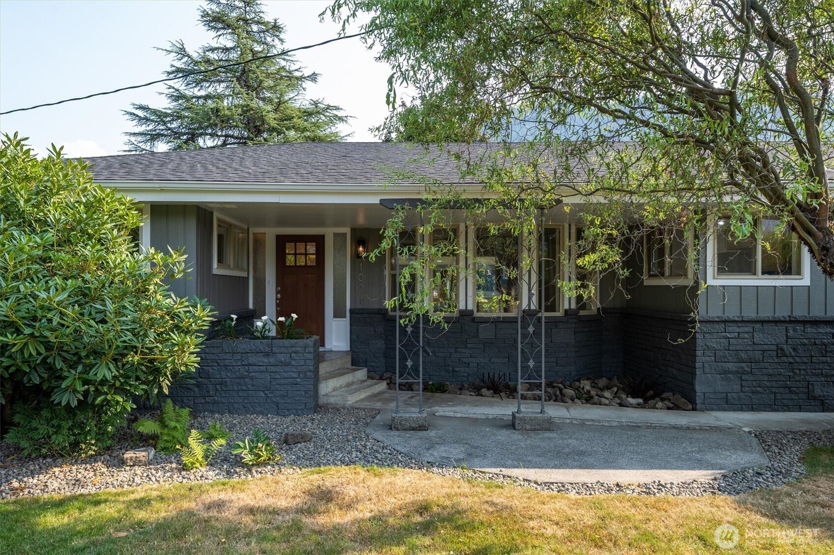 Welcome home. This large remodeled 3-bedroom 1.5-bath home located in the heart of Morton has it all at a great price!  The exterior has mature landscaping, fresh paint, and a huge covered deck for entertaining. The home sits on over a 1/3 of an acre and has a large garage and carport. The interior has new paint, LVP, and wall to wall carpet. Your kitchen has been updated with beautiful new wood cabinets, stainless steel appliances, quartz countertops and tile backsplash. The Primary Bedroom has a oversized closet and sliding glass door to the large covered porch. The bathrooms feature new vanities, countertops, paint, and flooring. This house is what you've been waiting for. Call your favorite agent for a showing!