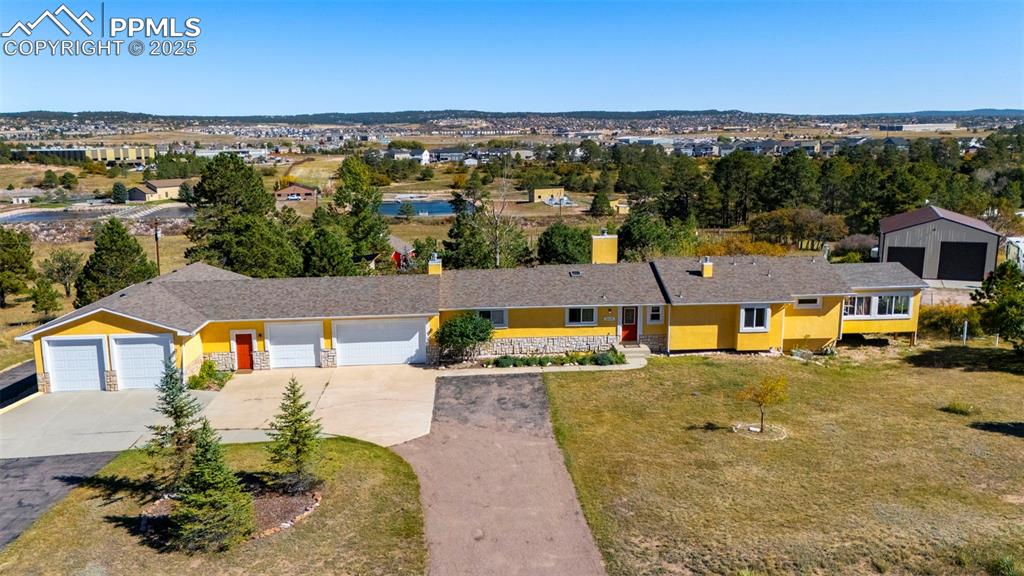 This beautiful home boasts stunning city views and picturesque vistas of the foothills, all while being conveniently located near city services. Don't miss this rare opportunity to own a hobby farm with a heritage orchard. An outdoor enthusiast's dream, this property is situated at the base of Mt. Herman, with hiking and biking trails just minutes away. Whatever your passion, this property has the perfect space for it! Enjoy the tranquility of country living, just minutes from downtown Monument.

Key features of the property include:

- 40 historic and endangered varieties of apple trees
- 68 total fruit-bearing trees
- A 24,248 square foot (over half an acre) food forest garden, expertly designed and maintained by a Master Gardener, featuring hundreds of different perennial food plants, including herbs, fruits, and vegetables
- A 6,345 square foot poultry pasture, complete with a coop and duck pond
- A 12,385 square foot dog run
- Mature pines and cottonwoods
- A 30'x40' heated steel pole barn with an RV bay
- Traditional Red Barn

The heated garage spaces are ideal for a home business, art studio, fitness gym, mechanical or fabrication work, as well as storing cars and RVs. The property also includes a heated "mancave" and "she-shed," a walk-out basement with great potential for an in-law suite, and a wet bar. Additionally, you'll find a sunroom and covered patio to enjoy.