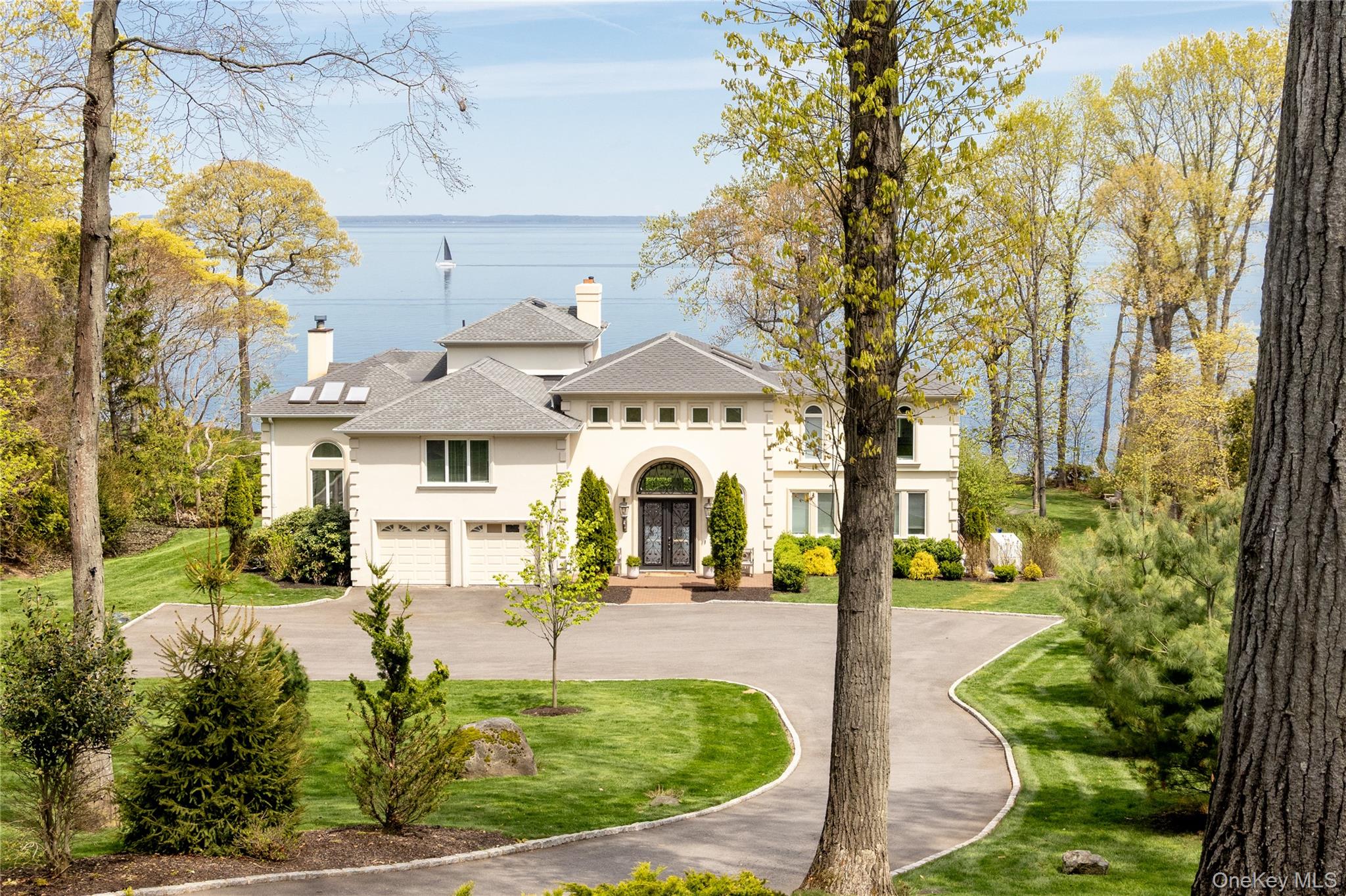 Reimagined and Rebuilt Waterfront Estate with Private Beach Access — Lloyd Harbor, NY.Located on one of the Long Island’s North Shore’s most coveted coastline stretches, this rare waterfront home offers privacy, natural beauty, comfort and understated prestige that have long defined Lloyd Harbor.Set on two acres overlooking the Long Island Sound, this extensively renovated residence is designed to maximize light, views, and effortless coastal living. Nearly every room captures water views, creating a constant connection to the surrounding landscape. Sun-filled interiors include five bedrooms and five-and-a-half baths, highlighted by a newly created primary suite with panoramic views of the Sound, a split staircase entrance and a luxurious ensuite bath with heated floors. Hardwood floors, thoughtfully crafted bathrooms, high-end appliances, and four fireplaces add warmth, comfort, and timeless appeal throughout. A newly finished lower level provides additional space for entertaining, recreation and accommodation.Outside, a new expansive Ipe deck overlooks the ever-changing waters of the Sound, while professionally landscaped grounds descend to a wide private path leading directly to your own stretch of beach. From sunrise walks along the shoreline to evenings watching the light fade across the water, the setting offers a level of waterfront living rarely available on Long Island’s Gold Coast. A new reinforced eight feet tall rock revetment protects the shoreline, while a whole-house generator provides year-round peace of mind.Residents enjoy exclusive village amenities, including the lifeguarded Lloyd Neck beach, tennis courts, all-year road maintenance and a dedicated police department, along with direct access to the trails, equestrian facilities, and thousands of protected acres at Caumsett State Historic Park Preserve and Target Rock Wildlife Refuge. Located within the acclaimed Cold Spring Harbor School District and approximately one hour from Manhattan, this is a rare opportunity to own a private waterfront retreat in one of the most sought-after communities.