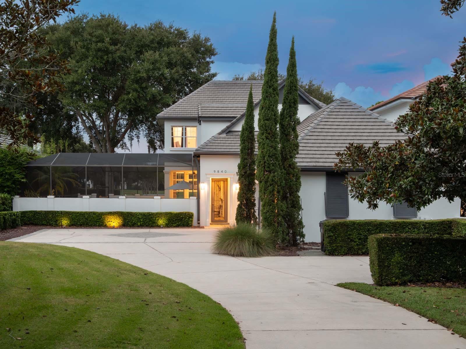 This private, tucked-away residence is perfectly located on the front nine of Lake Nona Golf & Country Club’s championship golf course. Thoughtful upgrades, an abundance of light-filled spaces and sensational sunset views distinguish this beautiful courtyard home. An expansive front yard, with mature landscaping and winding driveway, welcomes you into the screen-enclosed courtyard with a serene salt water, heated pool and spa. 

Elevated and updated finishes throughout the interior, including polished Italian travertine flooring, sleek light fixtures and custom tile selections, create a seamless integration of modern comfort and traditional beauty. The kitchen, sharing its space with an open dining area, features an oversized island with ample storage, elegant custom cabinetry and appliances by Wolf, SubZero and Bosch. A butler’s pantry with a wine fridge and storage is perfect for relaxing and entertaining alike. 

The first floor also includes a spacious owner’s suite with a spa-like bathroom retreat offering a freestanding tub, walk-in glass enclosed shower, with multiple spray options, and a large closet with ample shoe storage. The adjacent family room is anchored by a stunning entertainment wall, with fire place, and features French-door access to the covered lanai. 

A contemporary glass railed, lit staircase ascends to the second floor, which provides three bedrooms, including an additional owner’s suite. Accentuated by a convenient wet bar, the entertainment loft is flooded with natural light, and is in a prime location within the home. Opening to a rebuilt balcony, this room captures panoramic views of Holes #3, #4 and #5. Additional features include an outdoor grilling station, first floor laundry room and a three-car garage.