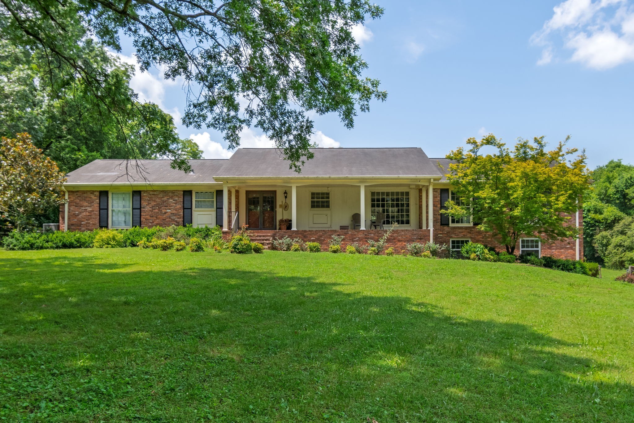 Tucked away on 5 flat, usable acres just off Neeley’s Bend, this all-brick ranch with a finished basement offers a rare blend of space, privacy, and opportunity. The main home features 4 bedrooms and 4 bathrooms, 2 car attached garage and a detached 3-car garage with an expansive 1,100 sq ft apartment or studio above—ideal for guests, rental income, music studio or office. Outside, you’ll find a barn equipped with electricity and water, beautiful oak trees complete with picturesque swing and plenty of room for your outdoor dreams—whether it’s a garden, animals, or simply enjoying the wild turkeys and deer that frequent the property.The home has solid bones and a peaceful, picturesque setting, the potential is undeniable with a little vision. This is a rare opportunity to create your dream home or multigenerational estate in one of Madison’s most serene locations, 1 mile to Peeler Park. Peeler Park Greenway meanders through Peeler Park, a 636 acre pastoral park tucked away at the end of a curve in the Cumberland River known as Neely’s Bend. Its bucolic setting on the river features a greenway, primitive hiking trails, equestrian trails, and an airfield for remote-controlled planes.