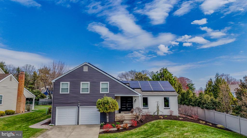 Perfectly positioned on a beautifully landscaped cul-de-sac lot, this exceptional contemporary residence offers refined style, thoughtful updates, and impeccable pride of ownership throughout. Surrounded by manicured grounds that will soon burst into full bloom, the home makes a striking first impression with newer wide-beaded vinyl siding, all newer windows, a timeless white brick façade, and a stunning custom double-door entry. Inside, a dramatic foyer with ceramic tile flooring and freshly painted crisp white walls introduces the home’s sophisticated, light-filled interior. Designed for both elegant entertaining and comfortable everyday living, the formal dining room is generously sized and accented by two oversized windows and recessed lighting, easily accommodating a large dining table and serving pieces.The adjoining living room is equally impressive, filled with natural light from a triple casement window and sliding glass doors that open to the outdoor entertaining spaces. Custom glass pocket doors lead seamlessly into the kitchen, creating both privacy and flow.The bright white kitchen is beautifully appointed with sparkling granite countertops and backsplash, abundant cabinetry, recessed lighting, and a skylight that fills the space with natural light. Premium appliances include a Dacor five-burner glass cooktop, double ovens, dishwasher, and refrigerator. The adjoining breakfast area features an Andersen sliding glass door leading directly to the deck, making indoor-outdoor living effortless.The family room is warm and inviting, anchored by a white brick wood-burning fireplace with a dramatic black mantel. Triple windows and an Andersen slider continue the home’s airy feel, while a custom wet bar with white cabinetry and a beverage refrigerator creates the perfect setting for entertaining.Even the laundry room has been thoughtfully reimagined with oversized marble-look tile flooring, a custom marble backsplash, and a utility sink set into white cabinetry topped with quartz. A newer exterior door provides convenient access to the side yard. A stylish powder room with pedestal sink and ceramic tile flooring completes this level.Upstairs, a striking black and white custom staircase leads to the private bedroom level. The spacious primary suite offers a serene retreat with neutral décor, plush carpeting, and a beautifully updated en-suite bath featuring a dressing area, white cabinetry, ceramic flooring, and an updated shower surround.Two additional bedrooms are generously sized with large windows and fresh neutral finishes. Uniquely, each bedroom enjoys access to its own full bath. The updated hall bath features gray cabinetry, quartz countertops, nickel fixtures, and a white tub with subway tile surround and niche. A third spa-inspired full bath offers the ultimate retreat, complete with a Jacuzzi tub, separate stall shower, white cabinetry with granite countertops, and custom granite accents set into the tile flooring.The fully finished basement provides exceptional flexibility with expansive space for a recreation room, home office, fitness area, or media lounge.Outside, the private backyard is an extension of the home’s living space. Landscape lighting beautifully illuminates the manicured grounds, while the expansive deck and stamped concrete patio provide the ideal setting for outdoor dining, entertaining, or simply relaxing in your own private oasis.Additional highlights include smart home technology controlling the garage doors, sprinkler system, and HVAC, as well as a newer roof and HVAC systems, both approximately 6 to 7 years old.An absolutely pristine home offering luxury, comfort, and convenience in an exceptional location just moments from major roadways, shopping, and dining.