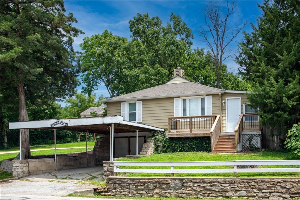 Tucked away on a rare 1.3-acre lot, this beautifully updated Lake Lotawana home offers the privacy and outdoor space that are nearly impossible to find. Completely remodeled inside, the 2-bedroom, 2-bath floor plan features an updated kitchen, remodeled bathrooms, new flooring throughout, and a warm, inviting living area anchored by a stunning stone fireplace and wood ceiling detail.Step outside to a brand-new patio overlooking the expansive yard, creating the perfect setting for entertaining, outdoor games, or simply enjoying the peaceful surroundings. Mature trees and generous green space provide a private retreat while still being close to everything Lake Lotawana has to offer.The lakefront includes a covered boat-well dock with lift and attached swim dock, making it easy to spend your days on the water. An unfinished basement provides excellent storage for lake toys, tools, and equipment. Whether you're looking for a weekend getaway or a full-time lake home, this move-in-ready property combines updated living, exceptional privacy, and a great waterfront setup in one unique package.