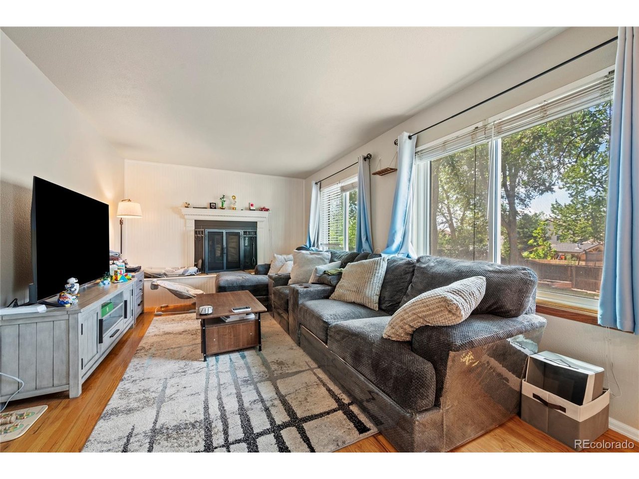 A luminous escape awaits in this inviting Aurora residence. Enter into an easily flowing layout beaming w/ warm hardwood flooring and fresh, neutral wall color. Adjoined for seamless entertaining, a formal living area opens into a dining room drenched in natural light from a wide window. An eat-in kitchen features newer appliances and outdoor connectivity. Enjoy relaxing in a spacious living area around the warm glow of a cozy fireplace. Three sizable bedrooms. The primary bedroom includes an on suite 3/4 bath and walk-in closet w/ built-ins. Flexible living space is discovered in a finished basement w/ room for a guest suite, home office or fitness area. Outside, a separate 300-square-foot building presents potential for a workshop, art studio or storage. An expansive backyard features an RV gate and parking, fenced dog run, garden area and fruit trees. Additional upgrades include a newer hot water heater and main sewer line. Enjoy an ideal Tollgate location w/ proximity to parks, schools, retail, restaurants and more.
