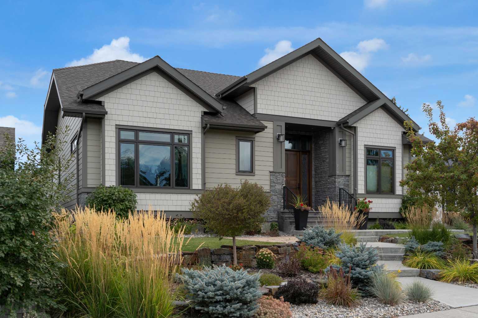 Welcome to this extraordinary custom-built bungalow, offering over 2,000 sq. ft. on the main floor plus a fully finished basement. Built in 2019, this home beautifully combines timeless craftsmanship with modern design, creating a warm and inviting atmosphere in one of Calgary’s most established neighborhoods.

From the moment you enter, soaring 10 ft ceilings and oversized windows (triple-pane with double Low-E, double Argon, and full metal-clad exterior) set the tone for an airy, light-filled space. The open-concept main level flows seamlessly, anchored by a stunning kitchen that inspires gathering—complete with a large island, walk-in pantry, and high-end Miele appliances: steam combination oven, full-size oven, speed oven, warming drawer, ceramic induction cooktop, and two dishwashers. The adjoining living and dining areas open gracefully to the outdoors, perfect for hosting or quiet evenings at home.

The primary suite is a private retreat, featuring expansive windows and a luxurious spa-inspired ensuite. Here, you’ll find a walk-in shower, dual vanities, and elegant finishes that make everyday living feel indulgent. A separate walk-in closet offers ample storage and thoughtful design, while convenient access to the main floor laundry is located just outside the suite for added practicality.

The finished lower level extends your living space, with a generous recreation area, wet bar with full fridge and dishwasher, wine cellar, fitness room, and three additional bedrooms—one with its own ensuite and walk-in closet. In-floor zoned heating throughout ensures year-round comfort.

Every detail of this home reflects a commitment to quality, from the building envelope finished with James Hardie siding and shakes, to the careful selection of features designed to maximize comfort and minimize maintenance. Professionally landscaped outdoor spaces further enhance the appeal, blending beauty with low upkeep to create a seamless living experience both inside and out.

An attached heated garage adds everyday convenience to this well-planned home.

Blending sophistication with functionality, this property is more than a home—it’s a lifestyle. A rare opportunity to own a truly spectacular residence in a mature, welcoming community just steps away from Fish Creek Park’s endless walking and biking trails, The Bow Valley Ranch, Annie’s Café, and Park 96, while still enjoying quick access to Deerfoot Trail and a short drive to shopping, dining, and amenities. Parkland offers the perfect balance of nature, convenience, and community spirit—whether you’re raising a family or seeking a peaceful, connected place to call home.