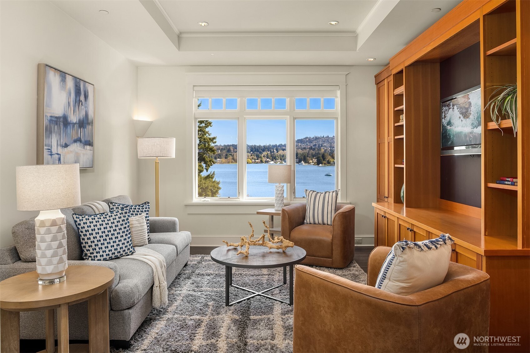 Step off the bonus room into a handsome TV space, where custom built-in cabinetry and sweeping views create a refined place to unwind.