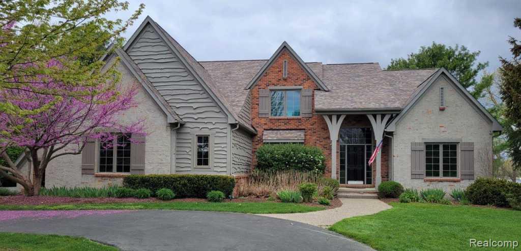 French Country home on 150 feet of lakefront in desirable Heather Lake Estates. Enjoy beautiful water views, a private dock, sandy beach area, and amazing sunsets. This quality Lorimer-built custom home sits on nearly 2 acres, set back from the road with a tree-lined drive and an oversized three-car garage. The interior features a two-sided fireplace between the kitchen and great room, hickory hardwood floors, and a cherry and granite kitchen. The spacious primary suite overlooks the lake, offering peaceful views and natural light throughout the day. A finished lower level includes an additional bedroom and large recreation area, perfect for family or guests. Located in a highly regarded neighborhood with excellent schools, this home combines comfort, quality, and a premier lakefront setting. Private, gated, lake park access  with beach.