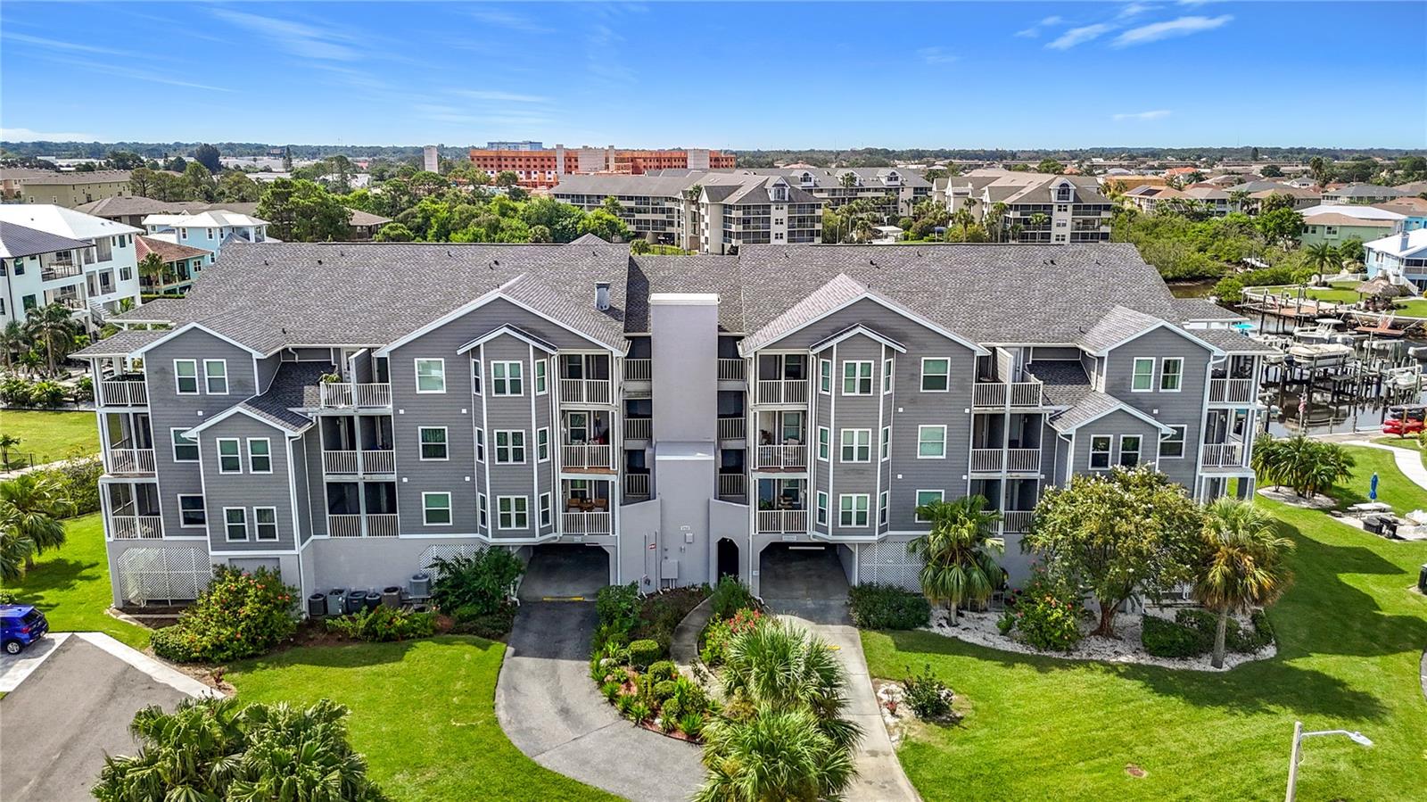 Incredible opportunity with spectacular views from this 3rd floor updated condo that includes a deeded boat slip with dedicated electric boat lift. This 2 bedroom, 2 bath home comes mostly furnished and is surrounded by beautiful waters, & abundant wildlife. Included in the sale is a 2017 18' Bayliner F18 Center console fishing boat & trailer, 115hp Mercury 4 stroke engine, Power pole, VHF marine radio, Simrod GO9 electronics with Less the 500 miles. Step into an open-concept layout designed with both entertaining and everyday tranquility in mind. The space flows effortlessly, allowing hosts to mingle during sunset cocktail hours or residents to savor a quiet morning coffee, all framed by breathtaking water views that serve as a living masterpiece. From virtually every vantage point within the residence, the Gulf stretches out before you. The kitchen boasts stunning granite countertops and a stylish backsplash that sets a sophisticated tone. With generous counter space, plentiful cabinets, and a pantry closet, culinary enthusiasts will feel right at home. The large primary bedroom is a true haven. Enjoy a super spacious walk-in closet, en suite bathroom, and a private balcony where you can greet the sunrise or unwind beneath the stars. The split layout ensures privacy from the guest bedroom, making this condo perfectly suited for snowbirds or full-time residents. Step out onto 1 of 2 balconies to soak in the panoramic water views. This vantage point is perfect for morning coffee, a good book, or an evening cocktail. Additional updates include Roof 2024, newer AC, Hurricane rated windows 2018, Hurricane rated sliding doors 2023, new laminate and new carpet in bedrooms 2023,siding 2023,new interior and exterior paint, auto dimmer lights in living room & kitchen, inside laundry room, alarm system, and a storage closet located adjacent to the elevator. Daily, you’ll be delighted by a parade of dolphins, enjoy watching a family of manatee that live in the cove, and a dazzling array of coastal birds: pelicans, herons, cranes, osprey, ibis, egrets. Community Amenities and Resort-Style Recreation include private covered parking and assigned space for ultimate convenience. Easy elevator access brings you directly to your condo—no stairs required. Community pool and clubhouse across the parking lot with a community heated pool for a refreshing dip or lounging beneath the sun, sauna, and jacuzzi located in Gulf Harbors main clubhouse. Membership in Gulf Landings Recreation Center and private beach club, offering countless amenities:Tennis and pickleball courts for friendly matches or active workouts. FLOOD INSURANCE INCLUDED IN CONDO FEES. Community boat ramp and assigned boat slip for easy access to the Gulf’s endless waterways, new dock planking, and new kayak launch dock, guest parking. Clubhouse with waterfront pool and spa for relaxation and social gatherings. Picnic areas with grills, plus a grilling station just steps from your condo. Extended dock for fishing, including a fish cleaning station for the day’s catch. Don’t miss this opportunity to create your own waterfront oasis in one of Florida’s most desirable boating communities! It is conveniently located to restaurants and (Publix) grocery store. Short drive to beautiful downtown New Port Richey…restaurants, shops, bars, and breweries. 6 miles to the Famous Tarpon Springs Sponge docks and only 22 miles to Tampa International Airport. Anclote Island and sandbar located 3 miles offshore.