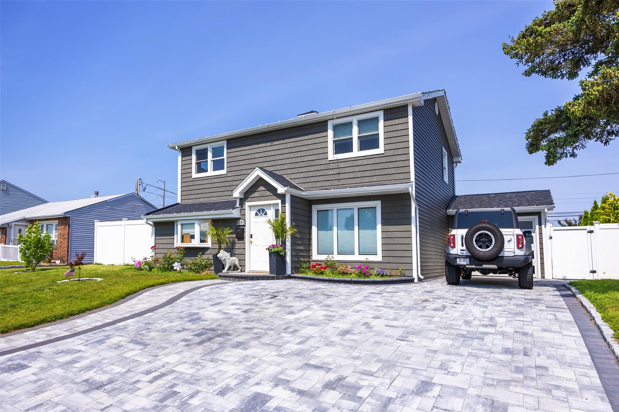 Welcome to this exquisite colonial nestled in the quiet Bethpage neighborhood!  It received a complete gut renovation about two years ago from the owner contractor with everything new and of great quality materials. It has 5 spacious bedrooms and 2 full baths. The first floor is open concept to include kitchen, dining room, living room, & one bedroom. The entire first floor has radiant heating. Upstairs has 4 generously sized bedrooms. Both bathrooms are of designer taste and quality. The huge backyard has an attached garage as well as a finished family room which is used as a gym and entertainment room. All rooms have split AC units. Both front and back yards have beautiful pavers.  The utility room is relocated to the back of the house. Zoned to the desirable Plainedge School District, this house is not to be missed!