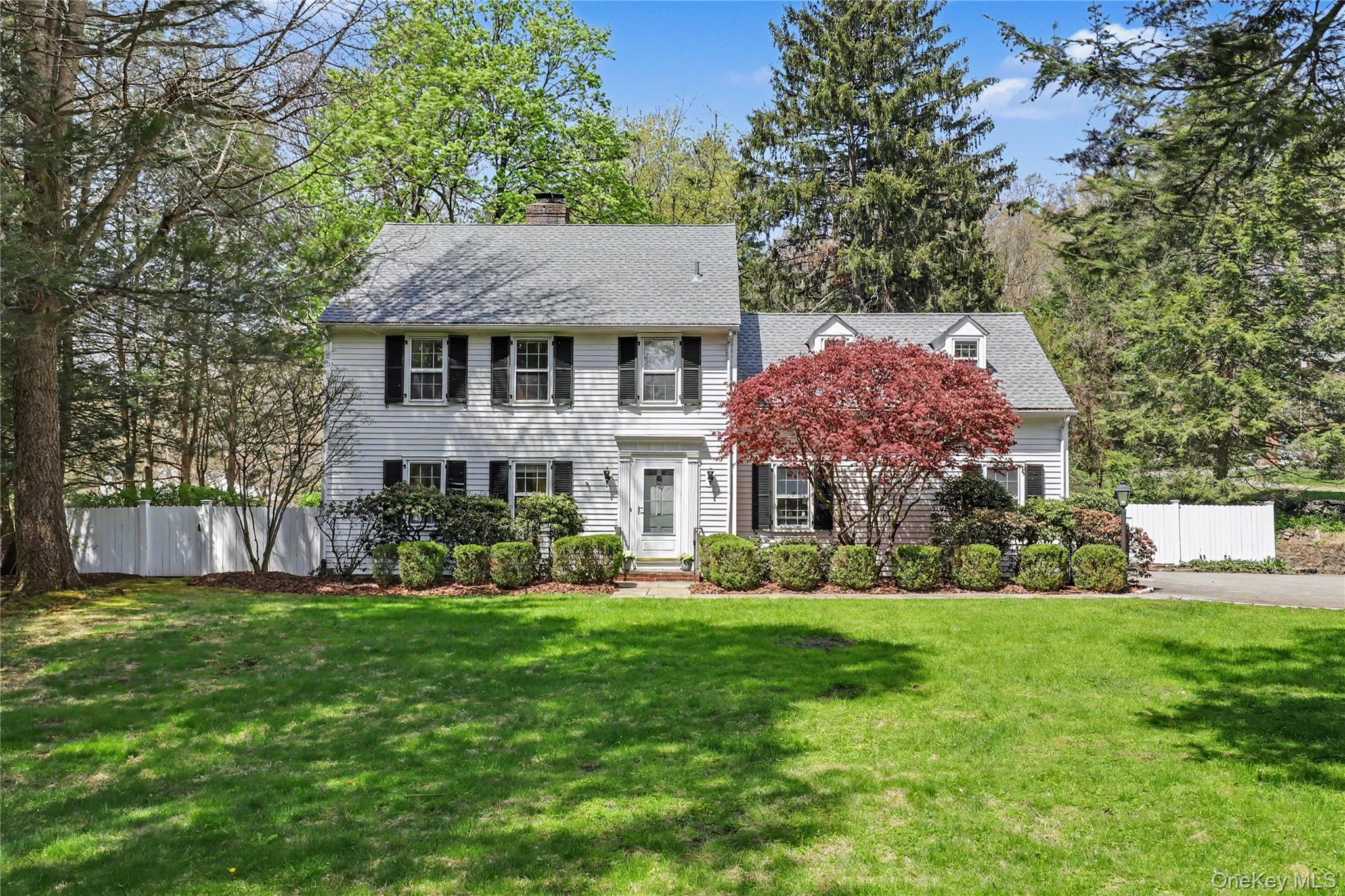This quintessential Bedford Village Colonial is a perfect blend of classic charm and everyday convenience, walking distance to Village shops, restaurants, library, town park and the Bedford Playhouse. The house lives like a four bedroom nestled on two lovely acres with level play area, tranquil pond, charming stone walls and specimen trees. You can fish in the summer and skate in the winter. The first level has a gracious entry, warm living room with fireplace, country kitchen, family room, office, laundry room and half bath. There is a beautiful back stone terrace overlooking the storybook setting, perfect for outdoor entertaining. Upstairs, there is a primary bedroom with full bath and two additional bedrooms and another full bath plus a bonus room. Hardwood floors throughout, Bosch appliances and new roof (2024). Room for expansion. A chance to live in the heart of Bedford Village. Not to be missed!