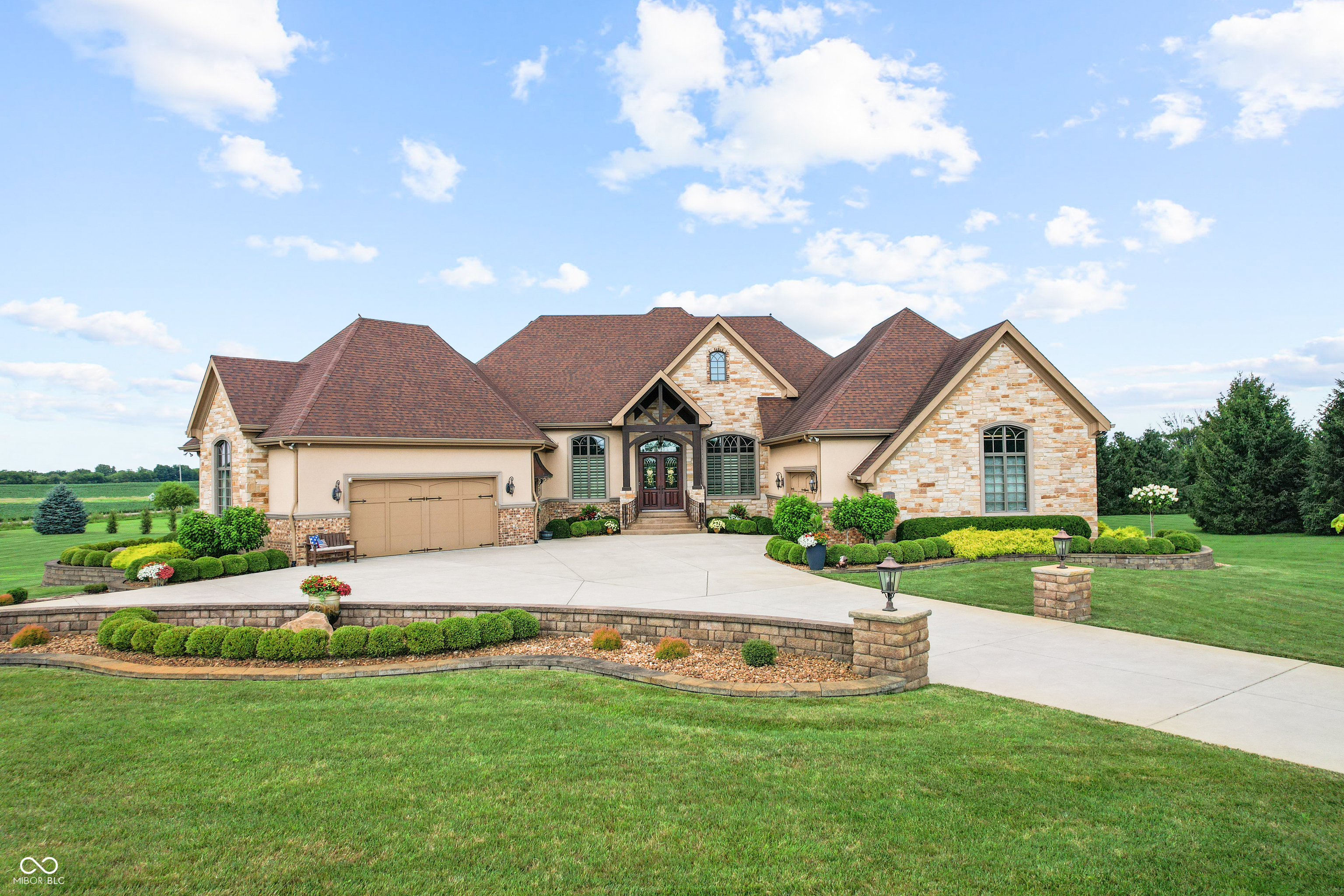 Welcome to refined living at The Legends Golf Club in Franklin, Indiana. This custom home sits on 2.8 beautifully landscaped acres with peaceful golf course views and an ideal blend of luxury, comfort, and craftsmanship.    Inside, the entire house has been freshly painted and features new engineered hardwood flooring that pairs perfectly with the home's rich woodwork and detailed trim. The kitchen is a true standout with a large island, quartz countertops, double ovens, wine fridge, ice maker, and stunning custom Amish-built cabinetry. The built-in fridge and pot filler add convenience, while the open layout flows into a spacious living area with built-ins and coffered ceilings, creating a warm and elegant gathering space.    The main-floor primary suite offers a quiet retreat with a walk-in tile shower, double vanities, and a custom walk-in closet with built-in cabinetry and center island. Just off the entry, you'll find a private office with natural light and easy access for guests or clients.    Outdoor living is just as impressive. Relax in the newly updated three-seasons room, take in the view from the composite deck, or enjoy the covered patio below. The walk-out basement adds even more space with a full bar and second kitchen, theatre room, game area, guest bedroom with full bath, and generous storage.    There are two separate two-car garages for a total of four bays, offering plenty of room for vehicles, hobbies, or a workshop. From the timeless finishes to the incredible setting, this home offers a rare combination of elegance, space, and location.