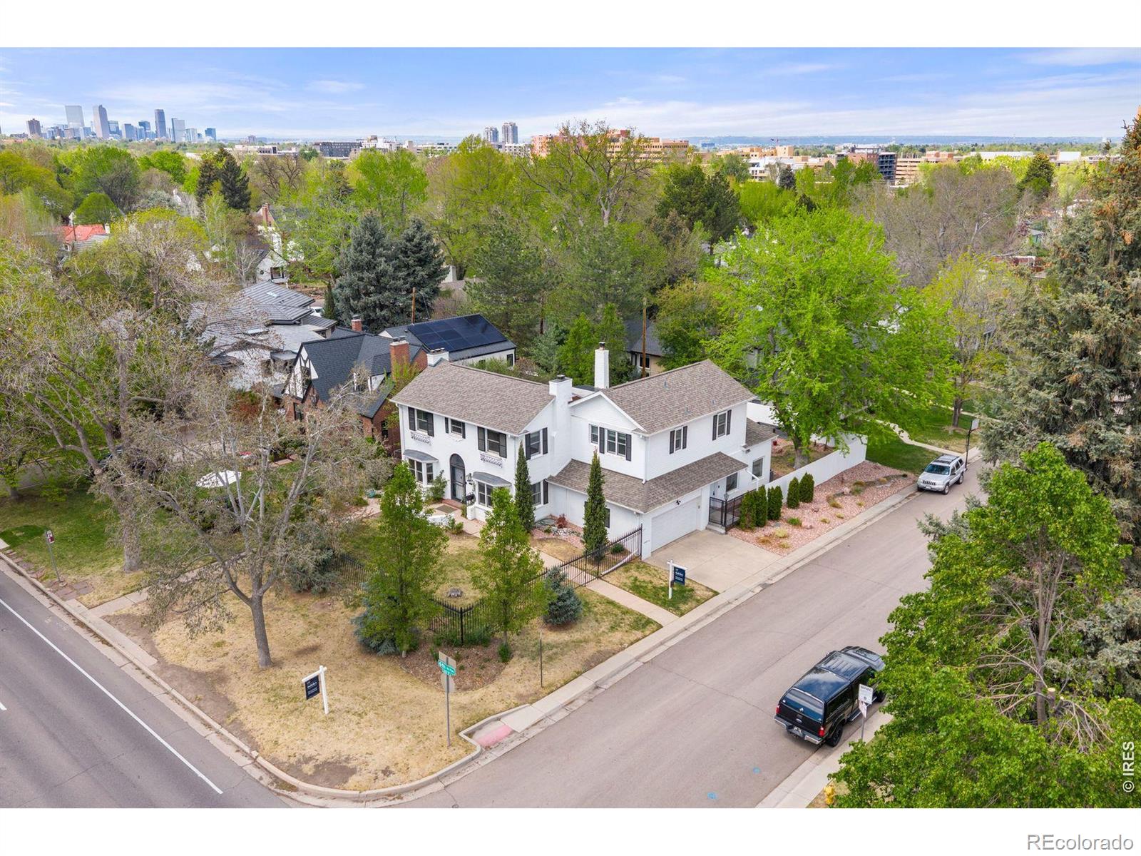 Originally built in 1937 and thoughtfully updated over time, this home blends historic character with modern functionality through a carefully designed addition. Many of the original architectural details remain, now paired with refreshed finishes, updated lighting, and improvements that support today's lifestyle. The main level offers a variety of gathering spaces that work equally well for entertaining and everyday living. A formal living room with a refreshed fireplace provides a comfortable place to welcome guests, while a separate family room with its own fireplace offers a more relaxed setting. The formal dining room connects to a catering kitchen with wine storage, creating a natural flow for hosting. The primary kitchen features quartz countertops, JennAir stainless steel appliances, and a bright breakfast nook with access to the backyard patios and lawn. A private office and renovated powder bath complete the main floor. Upstairs are four bedrooms, including two primary suites. The primary suite includes a sitting area, a five-piece bath, dual walk-in closets, a private laundry, and a balcony. The second primary bedroom has its own en-suite bath, while two additional bedrooms share a full bathroom. The home includes two lower levels, adding flexibility. The basement within the newer addition can function as a home gym, playroom, or media space. The original basement includes a bedroom, reading nook, full bathroom, and a second laundry area, making it well-suited for guests or extended stays. Additional updates include fresh interior paint, new lighting, multiple laundry areas, and an outdoor sauna. The landscaped front and back yards feature established rose bushes and two raised garden beds with drip irrigation. Zoned for Carson Elementary, located near Cherry Creek, the neighborhood Farmer's Market, and the trails along 6th Avenue Parkway, this home offers a balance of classic design and modern livability with convenient access to downtown Denver.