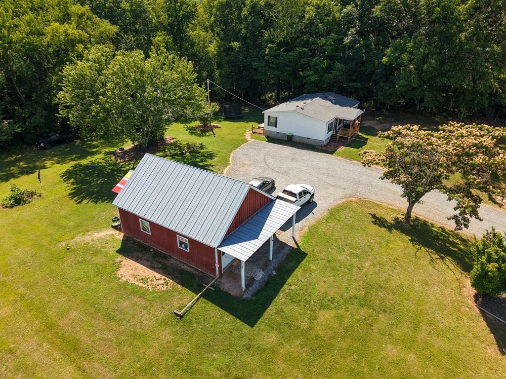 Country Living at Its Best! Enjoy peaceful country living just minutes from Mount Airy, NC, the Blue Ridge Parkway, and the North Carolina state line. This well-maintained home offers 3 bedrooms, 2 full baths, and a comfortable floor plan with numerous updates throughout. Relax on the covered front porch or entertain on the new rear deck overlooking the spacious yard. Inside, the primary suite features an ensuite bathroom with a walk-in closet, along with updated flooring throughout the home. Recent improvements include a new HVAC system and updated flooring, reflecting the care this property has received. Outside, you'll find a stick-built garage/storage building on a concrete slab with plenty of space for hobbies, a workshop, or additional storage. The garage also offers ample attic storage, and a lean-to shed provides even more room for equipment and outdoor essentials. The beautifully landscaped yard features attractive river rock accents and plenty of space to enjoy the outdoors. Conveniently located near Mount Airy, the Blue Ridge Parkway, and local amenities, this move-in-ready property offers the perfect blend of country charm, functionality, and convenience. Come see all this property has to offer!