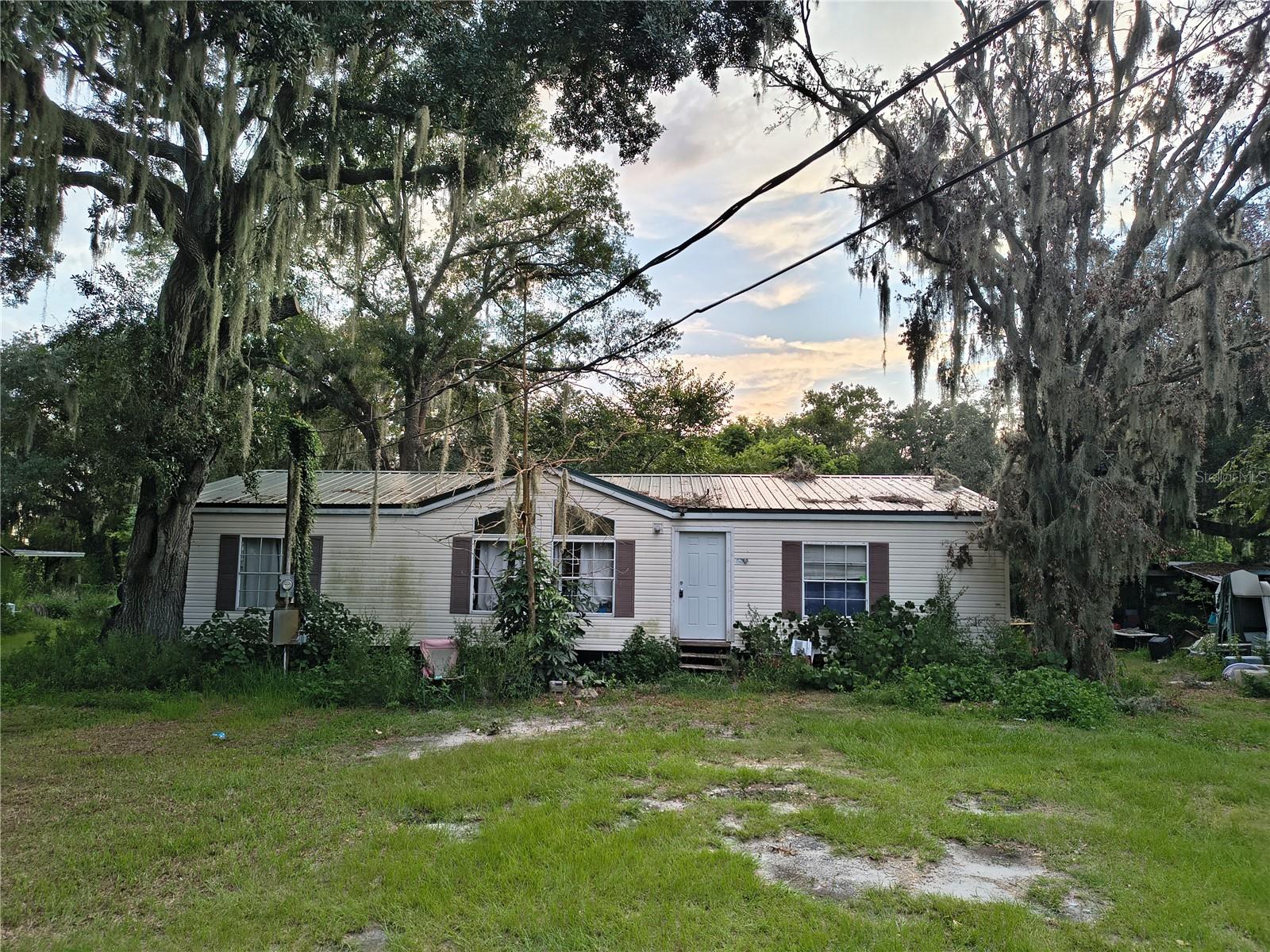 CASH ONLY – RELOCATED MANUFACTURED HOME-Home was previously located at another property and was relocated to its current location.-INVESTOR/REHAB OPPORTUNITY ON .76 ACRES IN A PRIME PLANT CITY LOCATION! Located conveniently between Plant City and South Lakeland, this 2004 manufactured home offers a fantastic opportunity for an investor, handyman, or buyer looking to create their own private country retreat. Situated at the end of a dead-end street, this property offers excellent privacy with no through traffic and plenty of room to enjoy the .76-acre lot. The home does need work and updating, and the AC is currently not operational, making this a true as-is, cash-only opportunity. Several important improvements have already been completed, including a metal roof approximately 6 years old, a new well pump approximately 2 years ago, and both the front and back exterior doors replaced within the past year. The septic tank was also pumped approximately 3 years ago. All bedrooms have nice size walk in closets and the spacious acreage provides plenty of possibilities for outdoor living, gardening, recreation, or even keeping a few chickens. The property is tucked away in a desirable, established neighborhood known for its quiet setting and friendly neighbors. Conveniently located between Plant City and South Lakeland, you'll enjoy easy access to shopping, dining, major roadways With limited turnover in the neighborhood, opportunities like this don't come along often. Cash buyers only. Property is being sold as-is. Buyer to verify all measurements, zoning, uses, utilities, and other property information.