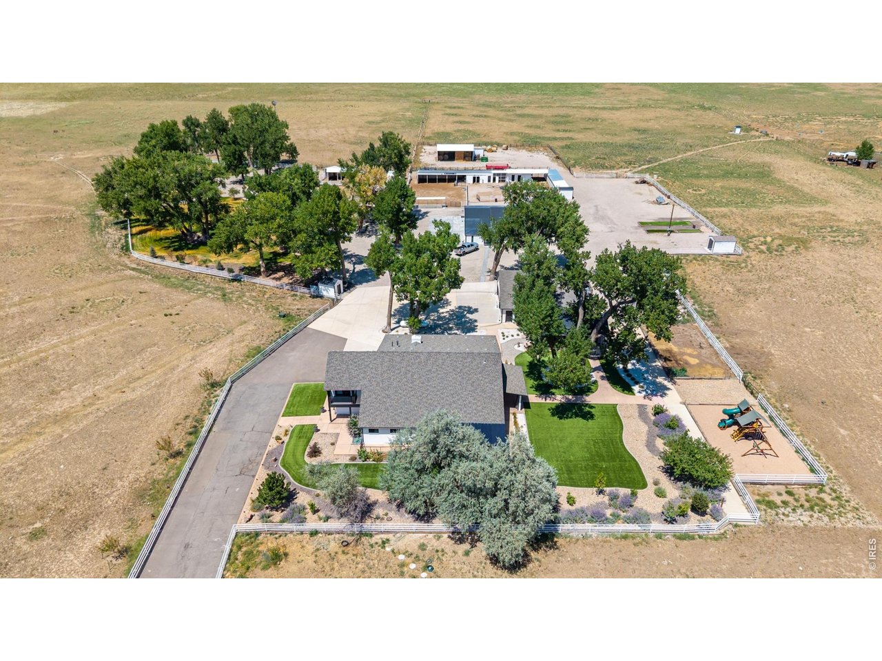 Welcome to an extraordinary 51+ acre ranch where luxury living meets the ultimate Colorado ranch lifestyle, perfectlysuited for a working ranch, equestrian operation, or agricultural business. At the heart of the property is a newlyrenovated 5,289-square-foot custom home with high-end finishes throughout. The chef's kitchen features a massiveisland, premium stainless-steel appliances, & a walk-in pantry with laundry. Formal living & family rooms provideexceptional entertaining space, while the dining room has a wood-burning stove. The two-story primary suite has asoaking tub, walk-in shower, custom walk-in closet with its own laundry, & private balcony. The main level also includes asecond bedroom with a 3/4 bath, powder room, & mudroom. Upstairs are 4 additional bedrooms, including one with aprivate balcony & ensuite, a Jack-N-Jill bath, hall bath, & a reading nook. Multiple patios create inviting outdoor living &entertaining spaces. A detached 5 garage includes a studio above, while a detached 4 garage offers separate livingquarters complete with a kitchen, bedroom & 3/4 bath ideal for ranch hands. Designed with functionality in mind, theranch offers exceptional infrastructure, including a dedicated horse barn with 4 stalls, a goat barn with 3 stalls, a loafingshed, fenced pastures, a round pen, multiple livestock shelters, hay storage, a metal shipping container, & 7 additionalstorage sheds located throughout the property. Poultry operations are equally impressive with 2 separate chicken coopareas, including a 5 stall coop & a newer, 57 stall coop. The property also features fuel pumps, an oil well, a water well, &fuel storage, providing added convenience & functionality for daily ranch operations. With more than 51 acres of usableland, there space for horses, cattle, goats, farming, grazing, recreation, & equipment storage. This one-of-a-kind FortLupton ranch offers an exceptional opportunity to experience the very best of Colorado ranch living.