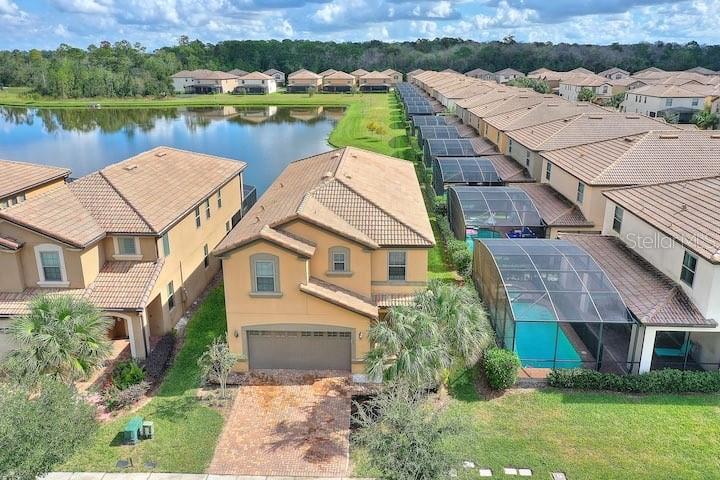 Welcome to this beautiful 7 Bed/ 5.5 Bath luxury vacation/investment home with WATERVIEW, nested in one of the most popular resort in Orlando: Windsor at Westside. This Turnkey vacation home comes with high end furnitures and professionally decorated and can easily accommodate up to 15 guests. Some great features of this house include spacious family/dining room combo, variety of game tables in the garage and upstair loft, spacious private pool/hot spa area in screened patio, which make it perfect for family and friends to gather for entertainment. Open kitchen is equipped with high-end cabinetry, granite countertops, and stainless-steel appliances. Spacious master suites on both floors are available to provide more comfort and privacy for owners and guests. The Windsor at Westside Resort provides massive amenities, including 8,000 square feet resort-style clubhouse, resort-style heated pool and spa, wireless internet on the pool deck, lazy river, recreation center, poolside cabana, playground, volleyball, tennis, basketball, game room, restaurant, bar, relaxing lounge area with indoor/outdoor fireplace, TVs and much more... This community is also in close proximity from Disney World and other attractions, like Universal Studios, Sea World, Golf courses, and Shopping Centers.Come check out this luxury and low maintenance vacation home before it slip away. Schedule a private showing today.