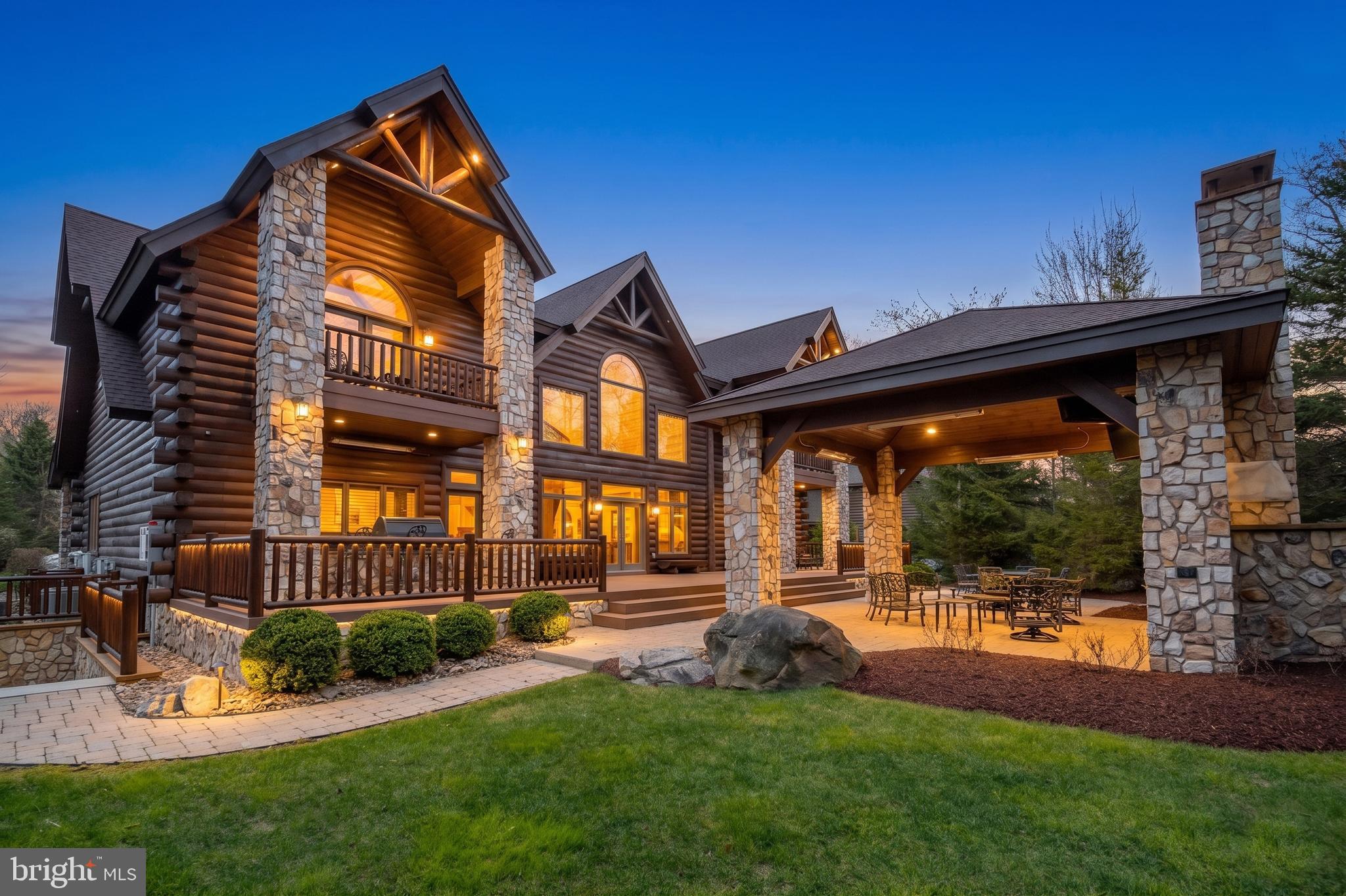 Experience the pinnacle of mountain luxury in this extraordinary custom log estate. Showcasing impeccable craftsmanship and refined rustic elegance, this one-of-a-kind retreat features a deluxe wine room, private sauna, billiard/game room, fitness area, large mudroom, and an indoor hot tub designed for year-round relaxation. Expansive windows from most rooms create a seamless connection to nature. The gourmet kitchen leaves nothing to the imagination, offering a six-burner gas range, large granite island, eat-in bar, cathedral ceilings, and access to the rear patio. The great room boasts a floor-to-ceiling stone fireplace and plenty of large windows that allow you to enjoy the beauty outside during any season. With six en-suite bedrooms and laundry on each level, your guests will be more than comfortable. The media/theatre room with an impressive wet bar is another bonus, and a great place to relax and have family time after a long day on the slopes. Picture hosting unforgettable cookouts with friends and family on the expansive rear brick patio, thoughtfully designed with a built-in grilling area, cozy fireplace, and a comfortable seating and TV area—perfect for relaxing or entertaining in style. With a 3-car attached garage and an epoxy floor, there is ample storage for vehicles and recreational toys. An additional, adjacent lot can also be acquired and provides enhanced privacy, making this an exceptional investment in mountain living. Conveniently located in the North Camp community atop Wisp Resort, premier skiing is just around the corner. There are also two golf courses close by, as well as all the recreation that Deep Creek Lake provides. Adventure and tranquility can both be yours from this remarkable haven!