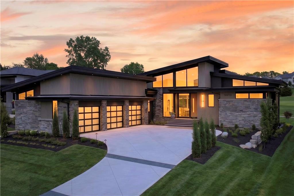 Experience exceptional luxury living in this spectacular new reverse 1.5-story home by Starr Homes. Overlooking the 8th hole of the Loch Lloyd Championship Golf Course, this architectural masterpiece is perfectly positioned within the prestigious gated community of Loch Lloyd, where residents enjoy a private 110-acre lake, scenic walking trails, and 24-hour gated security.An impressive front foyer welcomes you into an expansive open-concept living space where soaring ceilings, dramatic floor-to-ceiling windows, and oversized sliding glass doors flood the home with natural light while capturing breathtaking golf course views. Seamlessly blending indoor and outdoor living, the expansive covered lanai is designed for year-round entertaining with a full outdoor kitchen, grilling station, and spacious dining and gathering areas.The thoughtfully designed main level offers luxurious everyday living, while the walkout/walkup lower level is an entertainer's dream. Enjoy a state-of-the-art golf simulator, full wet bar, billiards area, stunning wine display room, and a hidden bourbon sipping room that creates an unforgettable private retreat.Every detail of this extraordinary residence has been thoughtfully curated to deliver timeless elegance, exceptional craftsmanship, and an unparalleled lifestyle in one of the Kansas City area's most exclusive communities.