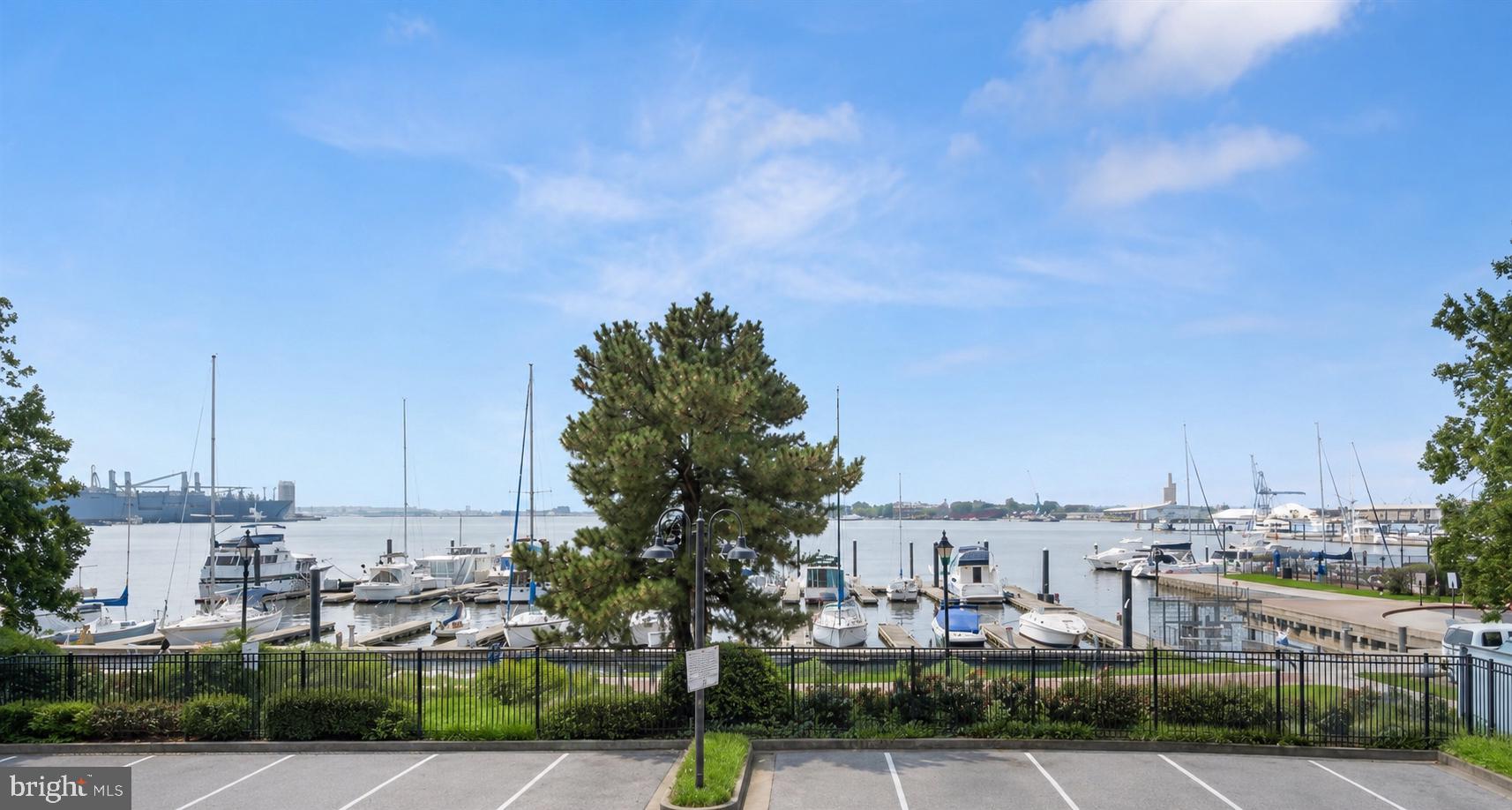 Extremely rare opportunity to own one of the largest residences available within the exclusive Canton Cove community.  This spacious three level townhome style condominium features 2,800 square feet of LUXURY CONTEMPORARY LIVING with panoramic floor to ceiling direct waterfront views.  **RECENT RENOVATIONS INCLUDE** Painting throughout the home, hardwood flooring on the main level, kitchen updates, new Ductless-Split system and wall-to-wall carpeting in the level one primary suite and new HVAC for levels two & three.  The main level covered balcony combined with the roof level observatory provide ample outdoor entertaining space and spectacular city skyline & water views.  Parking for two vehicles is provided for within the enclosed parking garage (parking space located directly next to the interior entry door) & the exterior surface parking lot (parking space located directly next to exterior entry stairway).  Building amenities include a fully staffed front desk to receive mail and packages, a private meeting room, private snow removal, waterfront promenade walking/jogging/biking path and beautifully landscaped grounds.  Multiple private marinas are located within close proximity for easy boating access.  A conveniently located water taxi can take you to explore any neighborhood in the city. With countless shopping, dining and entertaining options just minutes away from this centrally located Canton property you can enjoy a lifestyle offered nowhere else in Baltimore.