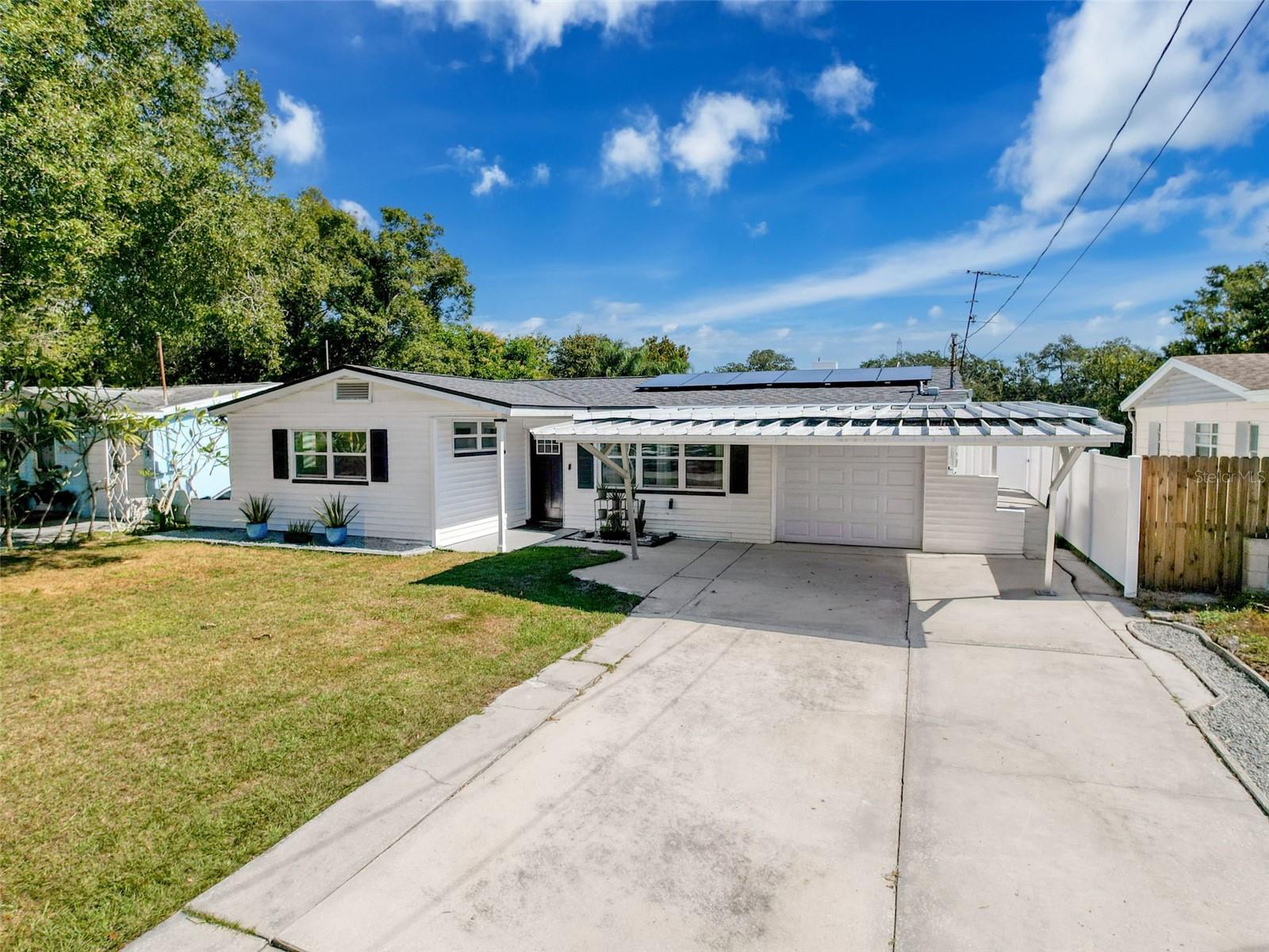 One or more photo(s) has been virtually staged. Welcome to your fully renovated coastal retreat in beautiful Clearwater, Florida! This thoughtfully updated three-bedroom, two-bath house offers stylish upgrades and a relaxed Florida lifestyle just minutes from everything you need—and want.

Step inside to discover an inviting open-concept layout, finished with new flooring throughout and bathed in natural light. A skylight in the spacious Florida room warms the space with sunshine, giving it the kind of glow you’d expect to find in a beachside cabana. Fresh interior and exterior paint bring a bright, modern touch, while the contemporary finishes carry through every room.

The heart of the home is its custom-designed kitchen. Fitted with wood cabinets, a ceramic farmhouse sink, marble backsplash, and new stainless-steel appliances, this space is as functional as it is visually appealing. A hidden walk-in pantry—complete with motion-sensing lights—adds convenience with a touch of high-tech charm. Whether you're a casual cook or a seasoned chef, this kitchen checks all the boxes.

Retreat to the primary bedroom and enjoy the comfort of an en-suite bathroom enhanced with porcelain tile, a sleek wood vanity, polished chrome fixtures, and a high-gloss ceramic sink. The guest bathroom is equally stylish, echoing the updated design found throughout the home.

Several major upgrades offer peace of mind for years to come. The roof and hurricane-rated garage door were replaced in 2022, new water heater 2025, along with brand-new plumbing throughout entire home, and energy-efficient windows 2022. A solar energy system was installed in 2023, helping to minimize utility costs while keeping your footprint light. The A/C system and electrical panel were also previously updated, ensuring this home is as efficient as it is comfortable.

Step outside to a lush backyard that overlooks a tranquil pond. Enjoy relaxing weekends on the re-screened lanai or fire up the grill on the bonus back patio. New turf grass has been installed for a green lawn all year round—without the maintenance. A fully vinyl-fenced yard offers privacy and a safe space for pets or little ones to play. Extra storage is never an issue here, thanks to a storage space attached to the garage.

Location? It doesn’t get much better. Sports fans will love being just minutes from the Phillies Spring Training Stadium, while beach lovers are a short drive from the world-famous Clearwater Beach. Downtown Dunedin and Safety Harbor are just 10-15 minutes away. Tampa Airport is just a 20 minutes away. Groceries, parks, restaurants, and shopping are all nearby, making daily errands easy. 

And here's the cherry on top—there are no homeowner association dues or community development fees. Consider this move-in-ready gem a rare find in today’s market. With so many upgrades and an ideal location, it won’t last long. Come take a look and see for yourself why this could be the perfect place to call home.