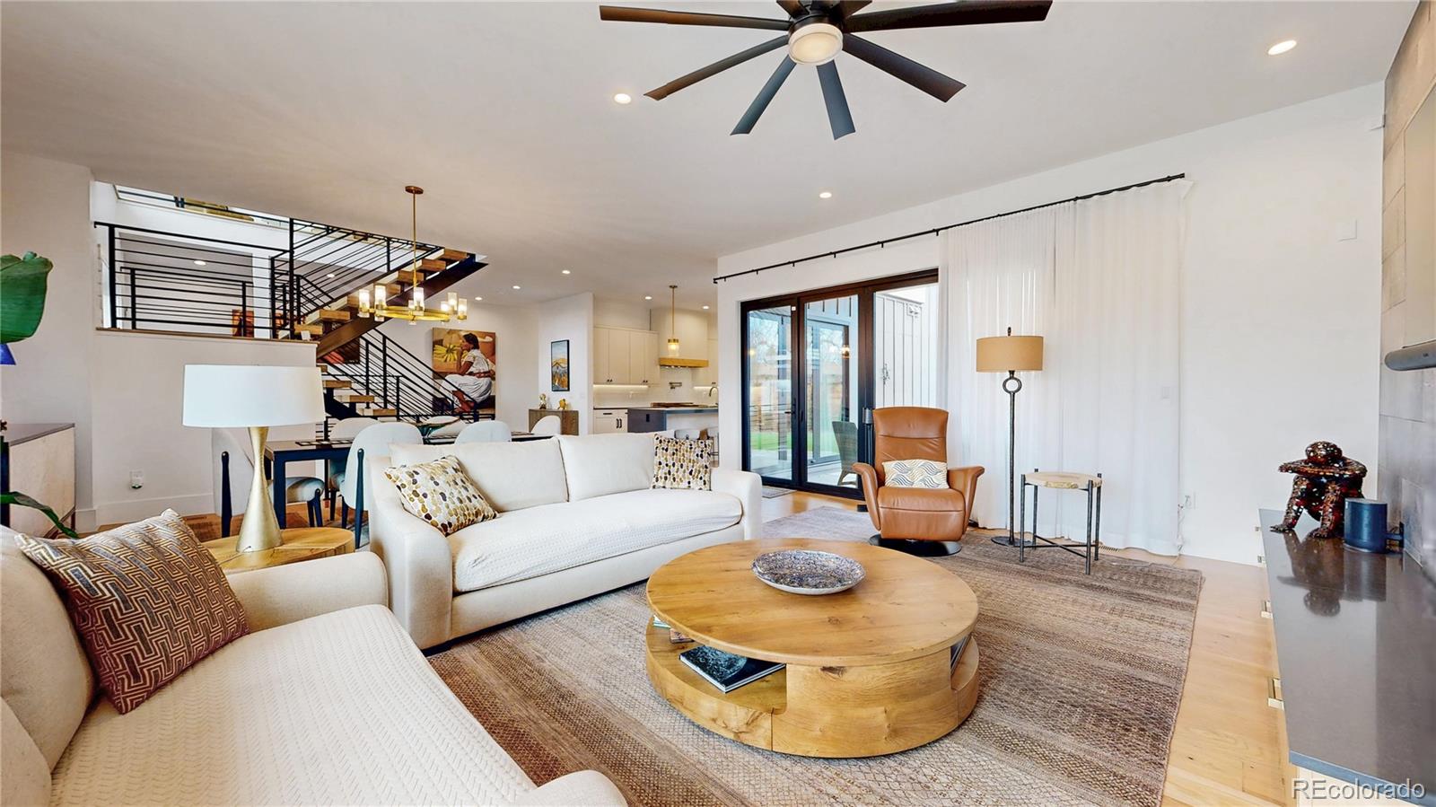 Situated between Sloan Lake and Highland Sq. Easy walk to either3 bedrooms top floor—2 baths top floor-One is 3/4 and the master is a 5 piece bath. Also a large deck off upper floor with custom made plantersMain level powder room, gorgeous kitchen with top of the line appliances, under cabinet lighting, quartz counters, built expressor machine, pot filler, dining room, Wide plank wood floors, gas fireplace, living room built ins, living room has large accordian glass doors flowing out to the covered patioBasement 1 bedroom and 1  3/4 bathUpgrades after purchase: $55,000 / 22 panel solar system$35,000 Landscaping. New tree and bushes front and back$22,000 custom window coverings$22,000 Custom made window coverings Upgrades paid separately to developer:$10,000 EV charger in garage, Coat closet from garage entry, Epoxy garage floor