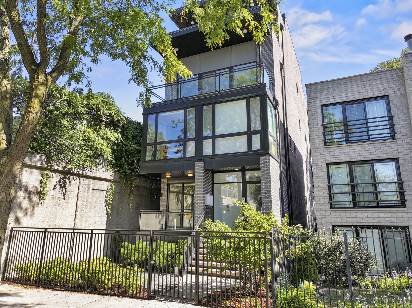 Welcome to this stunning 4 bed, 2.5 bath duplex-down at 1759 N Campbell Ave, Unit 1 - perfectly situated in an unbeatable West Bucktown/Logan Square location just steps from The 606! Built in 2019, this home truly lives like a single-family residence, blending elegant entertaining areas with the comfort of all bedrooms on one level.  The main floor features an expansive living room with floor-to-ceiling windows and access to a private front balcony that floods the space with natural light. The dining room offers the perfect setting for gatherings, while the professionally designed kitchen boasts Thermador appliances, Italian cabinetry, quartz countertops, and a waterfall island. Just beyond, a cozy family room with fireplace opens to a rear deck for grilling and entertaining. A stylish powder room completes the level.  Downstairs, radiant heated hardwood floors run throughout. The luxurious primary suite includes dual walk-in closets with custom built-ins and a spa-caliber bath with double vanity, steam shower, soaking tub, and water closet. Three additional spacious bedrooms share a full bath with dual vanity. A full-size laundry center and direct access to the carport add convenience. All of this is located just 2.5 blocks from the Western Blue Line, 1 block from The 606 entrance, and close to Maplewood & Lucy Flower Parks, plus the best dining, shopping, and nightlife of Logan Square, Bucktown, and Wicker Park. Truly a must-see home in a phenomenal location!