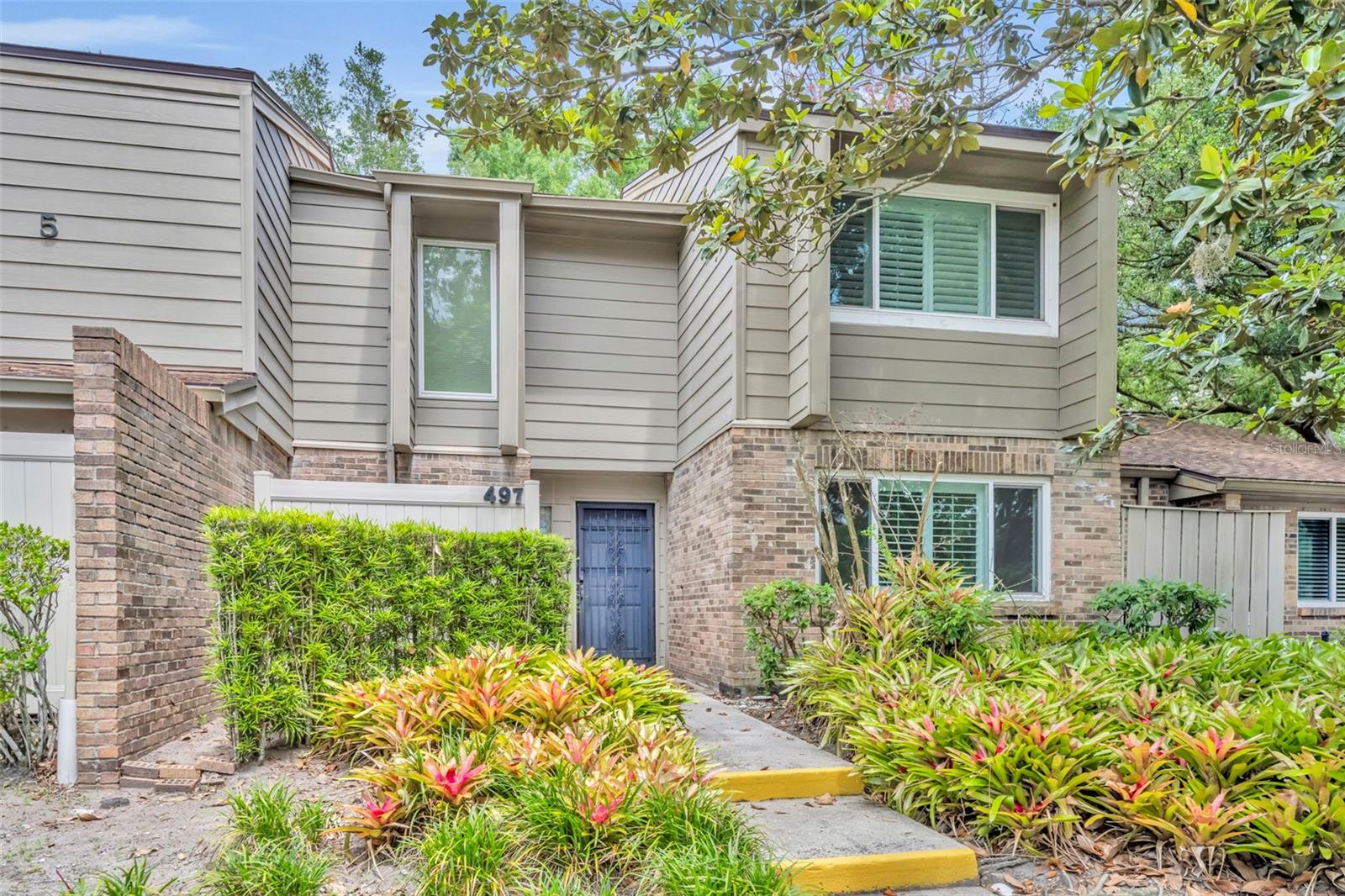 Welcome to 497 Oak Haven, a well maintained 2 bedroom, 2.5 bathroom condo tucked beneath a beautiful tree canopy in one of Altamonte’s hidden lakefront communities. With 1,792 square feet, this home offers great space, privacy, and flexibility. Downstairs you’ll find vaulted ceilings in the living room, a dining area off the kitchen, and an additional room with a closet that works perfectly as an office, guest room, or possible third bedroom. It sits next to the half bath, which could potentially be converted to a full bath if desired. The kitchen has wood cabinetry, a breakfast bar, and has just been freshly painted. Sliding glass doors open to a private fenced brick patio that’s ideal for grilling, pets, or simply enjoying the quiet green space behind the home. Tile flooring runs throughout the downstairs, while upstairs features two generously sized bedrooms with newer paint and carpet. Major updates include Pella windows installed in 2020 and a 2020 roof. The seller has lovingly maintained the property for the last 30 years. Residents enjoy two swimming pools, clubhouse, tennis courts, sauna, shuffleboard, basketball court, grilling area, and lake access to Lake Orienta with canoe and kayak rack storage. Gated community with two deeded parking spaces, all conveniently located just minutes from I-4, 436, Winter Park, Maitland, and Altamonte Mall.