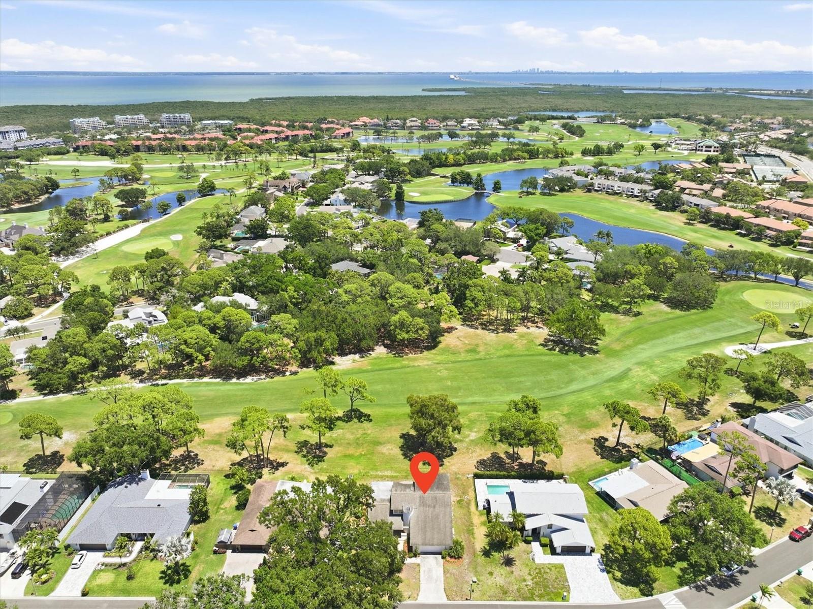 Welcome home to this beautifully updated contemporary home with direct golf course frontage in the highly sought-after Feather Sound Country Club community. This spacious four-bedroom, three-bath residence offers an exceptional blend of modern comfort, elegant design, and resort-style living in one of Tampa Bay’s most desirable golf course neighborhoods.  Inside, the home features soaring vaulted ceilings, expansive windows, and abundant natural light that fills the living spaces throughout the day. Beautiful golf course views create a peaceful backdrop from many of the home’s main living areas, while the open contemporary layout is ideal for both everyday living and entertaining. Enjoy beautiful evenings relaxing on your covered lanai overlooking the fairway; a pool would be a lovely addition, if desired. Thoughtful updates and refined finishes throughout the home create a sophisticated yet welcoming atmosphere. The oversized primary suite serves as a luxurious private retreat with generous proportions, tranquil views, and exceptional comfort. Spacious secondary bedrooms and flexible living areas provide plenty of room for family and guests.  Step outside and enjoy breathtaking fairway views and the serenity of direct golf course living in one of the area’s premier country club communities. Feather Sound Country Club members enjoy access to a championship 18-hole golf course, tennis facilities, a resort-style swimming pool, and an elegant clubhouse with dining and social events — all conveniently located within the community. Perfectly positioned in the heart of Tampa Bay, this home also offers exceptional convenience with easy access to Tampa, St. Petersburg, the Gulf beaches, and Tampa International Airport, making commuting, travel, shopping, dining, and entertainment effortlessly accessible. This is Florida country club living at its finest — combining luxury, natural beauty, and an unbeatable location in one extraordinary home.