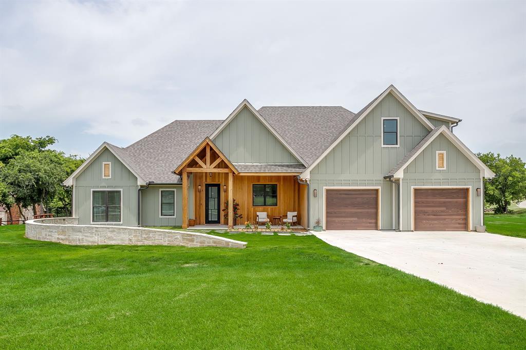 OFFERING A 1% LENDER CREDIT to help with closing with preferred lender! Newly constructed and barely lived in, this custom corner-lot home sits on just over an acre. A welcoming front porch sets the tone, creating an inviting first impression that feels right at home in the Texas countryside. Inside, the open-concept design is filled with natural light, bringing together the spacious living room, dining area, and chef's kitchen into one seamless gathering space. The kitchen is thoughtfully designed with a large center island, double convection ovens with sous vide, and a separate prep kitchen complete with an additional sink and generous pantry storage. The private primary suite continues the home's ranch-inspired charm, featuring a luxurious ensuite bath with a striking onyx-tiled walk-in shower, separate vanities, and an oversized walk-in closet that connects directly to the laundry room for added convenience. The first floor also offers two secondary bedrooms and a full bath with dual sinks and walk in shower, a stylish designer half bath, and a dedicated office or flex room that can easily adapt to your family's needs. Upstairs, a private guest suite with a full bath provides the perfect retreat for visitors or multi-generational living. Step outside to the covered back patio and spend your mornings watching deer and other native wildlife wander through the surrounding landscape while enjoying the peace and privacy of country living. The oversized two-car garage includes a secure gun safe that also serves as a Texas storm shelter. Offering the perfect balance of privacy and convenience, this exceptional property is just minutes from Highway 287, providing an easy commute to North Fort Worth while still delivering the quiet charm of life in the country.
