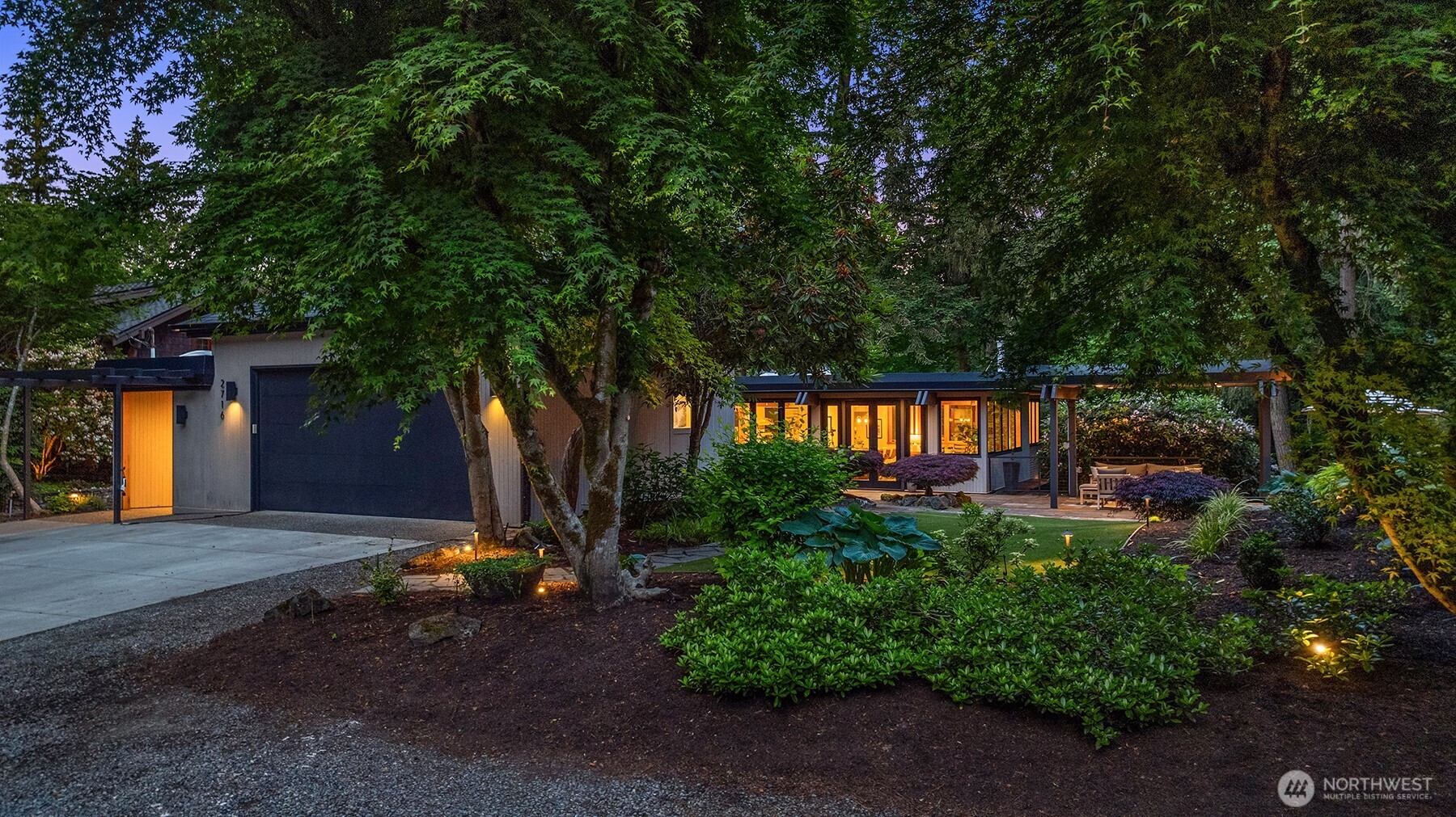 Inviting mid-century modern exterior glowing at twilight