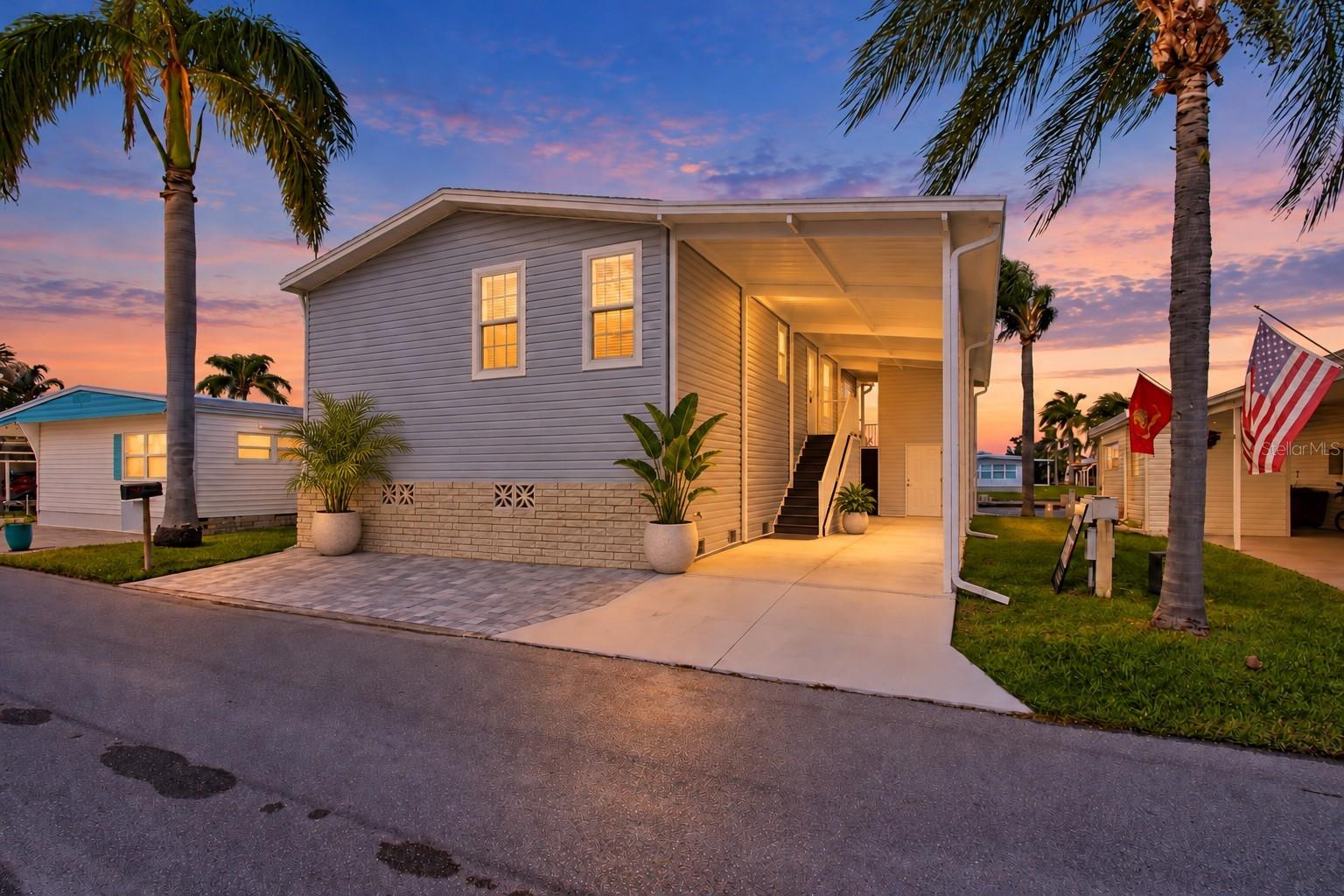 Virtually Staged. BRAND-NEW WATERFRONT HOME WITH PRIVATE BOAT DOCK & LIFT IN CLEARWATER!Discover exceptional Florida waterfront living in this BRAND-NEW, RAISED 3-bedroom, 2-bath DOUBLE-WIDE MANUFACTURED HOME  in Bay Aristocrat Village, a desirable 55+ resident-owned waterfront CO-OP community in Clearwater, Florida! Overlooking a WIDE WATERFRONT CANAL, this beautifully finished home offers quality vinyl flooring, REAL WOOD CABINETRY, beautiful countertops, stainless steel appliances, and a spacious CENTER ISLAND ideal for everyday living and entertaining. Enjoy the convenience of a dedicated indoor laundry room, abundant interior storage, and a HIGH-CEILINGED EXTERIOR STORAGE ROOM for boating gear, bicycles, and more.  Your Florida lifestyle truly begins outdoors! Relax on the impressive 8' x 24' COVERED WATERFRONT LANAI, offering approximately 192 square feet of outdoor living space where you can enjoy morning coffee, beautiful water views, and refreshing coastal breezes. Front of home includes new Fresh Driveway and gorgeous exterior pavers + Large under carport storage room with flor to ceiling access plus second staircase to back covered patio/porch and back sliders to your waterfront oasis!  BOATING ENTHUSIASTS WILL LOVE THE PRIVATE BOAT DOCK AND LIFT exclusively serving this residence, subject to the community's governing documents. Imagine having your boat just steps from home, ready for your next adventure on the water!AMENITIES & COMMUNITY LIFESTYLE! Bay Aristocrat Village offers an active social atmosphere centered around its spacious CLUBHOUSE, featuring a large gathering hall with a COMMERCIAL-GRADE KITCHEN, perfect for community dances, live performances, banquets, meetings, and year-round activities. The hall may also be reserved for private gatherings. Additional amenities include a comfortable lounge, game room, library, business office, and public restrooms. Residents and guests can enjoy FREE Wi-Fi throughout the clubhouse and pool deck, along with advanced performance lighting and an HD projection and integrated sound system for community entertainment.Bay Aristocrat Village is a WATERFRONT CO-OP COMMUNITY where owners hold a percentage interest in the corporation, subject to the cooperative's governing documents. Conveniently located near shopping, dining, entertainment, medical facilities, and Clearwater's beautiful Gulf Coast beaches!BRAND-NEW HOME. RAISED CONSTRUCTION. PRIVATE DOCK & BOAT LIFT. WATERFRONT VIEWS. CO-OP OWNERSHIP. THE FLORIDA LIFESTYLE YOU'VE BEEN DREAMING OF!  Whether you're looking for a year-round residence or a seasonal Florida getaway, this exceptional waterfront home offers the perfect combination of NEW CONSTRUCTION, COMFORT, COMMUNITY, AND COASTAL LIVING! Schedule your private showing today! Rentals allowed, 55+ Commuunnityy, Buyer and agent to verify all room sizes and rules, regs and info with HOA.