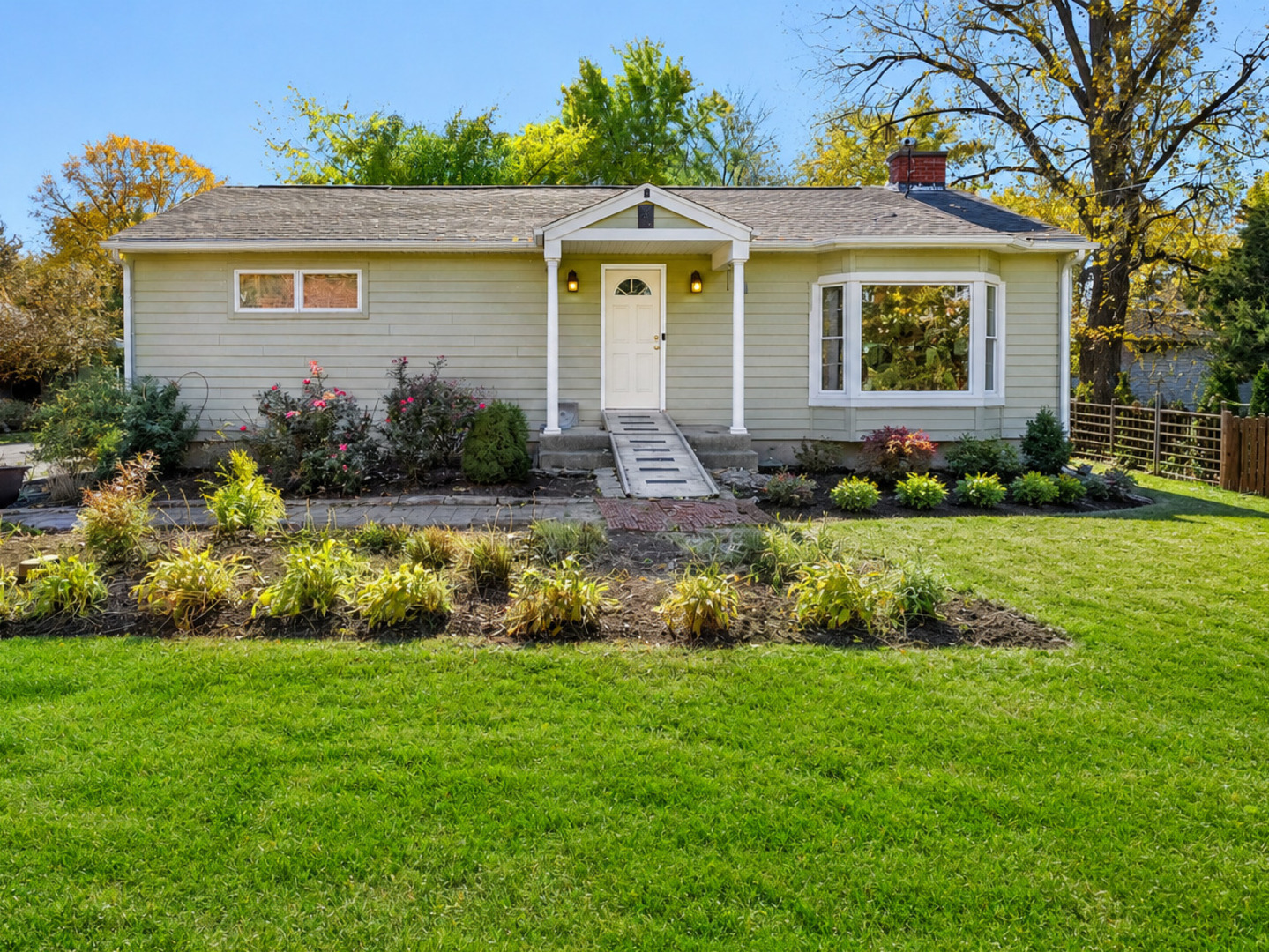 An Incredible Opportunity to Own in Downers Grove at an Exceptional Value! This darling ranch home combines affordability, space, and location, making it one of the best entry points into one of Downers Grove's most sought-after communities. Nestled on a quiet street surrounded by wonderful neighbors and just blocks from Highland Elementary, Herrick Junior High, and highly acclaimed Downers Grove North High School, this home is a rare find, indeed. Step inside to discover beautiful hardwood floors, crown molding, and a welcoming living room highlighted by a large bay window and cozy wood-burning fireplace. The spacious eat-in kitchen is truly the heart of the home, featuring abundant cabinet and counter space, newer appliances, wood laminate flooring, and room for a large dining table-perfect for gathering with family and friends.  Offering 3 bedrooms and updated full bath, the home blends charm with thoughtful improvements. The remodeled bathroom features timeless subway tile, updated vanity, and tile flooring. The primary and second bedrooms showcase hardwood flooring and generous closet space. The enormous full walkout basement dramatically expands the living space with a family room, third bedroom, bonus room, laundry area, extensive storage, a rough-in bath is already in place, creating the opportunity for additional equity and value. Outside, you'll find a private backyard oasis set on nearly one-third of an acre, complete with mature landscaping, gorgeous perennial gardens, a brick paver patio, fire pit, and a low-maintenance Trex deck-perfect for relaxing or entertaining. A large kitchen addition also added a practical mudroom with large pantry. A rare highlight is the oversized detached side-load 3-car garage featuring a heated hydronic workshop, dedicated sub-panel, and incredible space for hobbyists, contractors, car enthusiasts, or additional storage.  Major updates include fresh paint, newer windows, updated electrical panel, furnace, air conditioning, water heater, sump pump with backup battery, and more-providing peace of mind for years to come.  Conveniently located minutes from shopping, dining, parks, expressways, downtown Downers Grove, and Good Samaritan Hospital, this property offers an unbeatable combination of value, functionality, and location. With its spacious floor plan, enormous basement, private yard, and highly desirable schools, this is a rare opportunity to enjoy all that Downers Grove has to offer!