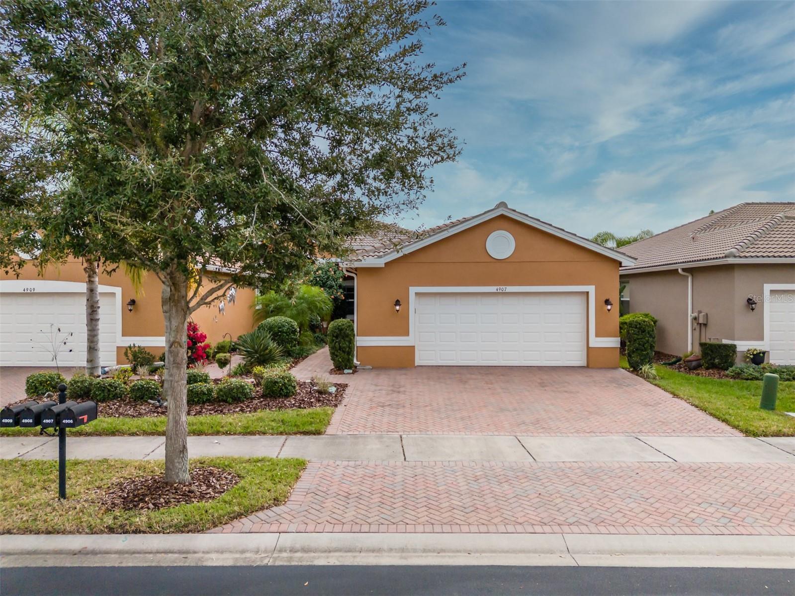 Welcome to Valencia Lakes, Tampa Bay’s premier 55+ Active Adult Community where resort-style living meets everyday comfort. This beautifully upgraded VICTORIA Regal Twin Villa offers 1,710 square feet under air, featuring 3 bedrooms, 2 baths, serene privacy, and abundant space to enjoy the idyllic Florida lifestyle. A full width driveway fronts the home. Manicured gardens lead to a covered portico, the perfect space to relax and take in Florida’s natural beauty and year-round pleasant temperatures. Inside, 9.5” x 60” laminate flooring flows seamlessly throughout the home, with tile in the bathrooms.The gourmet kitchen is a true standout, thoughtfully designed for both form and function. It features solid wood cabinetry with soft-close drawers and doors, two pantry cabinets with pull-out shelving, luxurious granite countertops, a stylish glass backsplash, and a bar-height breakfast counter accented by 3 decorative pendant lighting. Samsung S/S appliances include a slide-in range, 3-drawer refrigerator, microwave, & dishwasher. A casual dinette area with an 8’ window creates the ideal space for morning coffee or casual meals. The 13’x12’ dining room is highlighted by a large double window with up & down folded blinds, and it will comfortably accommodate eight. The spacious great room features a Harbor Breeze Saratoga 60” LED lighted ceiling fan and has access through 12’ sliders to the fully screened in lanai. The lanai offers the perfect space to relax, entertain, or simply enjoy the serene water view.The primary suite, located at the rear of the villa, offers tranquility and privacy with two generous walk-in closets, a Minka-Aire Light Wave ceiling fan, and a well-appointed ensuite bathroom. The ensuite features separated vanities with quartz counters, a large walk-in shower with safety bars & privacy glass window, and a W/C for the comfort-height commode. Bedroom 2, situated at the front of the home, provides exceptional comfort and privacy for guests and includes a lighted Minka-Aire Concept lighted ceiling fan. Bedroom features double French doors, a built-in closet, and a lighted ceiling fan, and will be ideal as a bedroom or home office.  How will you use this space? The second bathroom offers a quartz banjo countertop, a comfort-height Sterling toilet, tiled tub/shower, privacy glass window, and porcelain tile flooring. The laundry room is pre-plumbed for a utility sink and includes a front-load Whirlpool washer and dryer on pedestals for added convenience and storage. The oversized garage is equally impressive, featuring a luxurious epoxy floor, wall-mounted cabinetry, two overhead storage racks, an insulated garage door, and a belt-drive Lift Master opener with MyQ technology. The garage is also pre-plumbed for a water softener.Additional features include a Goodman HVAC system, hot water heater, and a 200-amp electrical panel, ensuring comfort and reliability.Valencia Lakes is a true world-class community featuring a 40,000SF Clubhouse, a 5,000SF State of the Heart Gym, 2 Multi-purpose Exercise Rooms, a Resort-style Pool, Resistance Pool, Spa, 5-Lane Lap Pool, Steam Baths, Saunas, 7 Pickleball Courts, 6 USTA Har-Tru Tennis Courts, 4 Bocce Lanes, 4 Shuffleboard lanes, Half-Court Basketball, the best Softball Stadium in the local area, a Dog Park, Garden Plots for the Green Thumbs, over 100 clubs and a Memorial Circle in honor of those who have served.Seize the day and make your dreams, your reality.