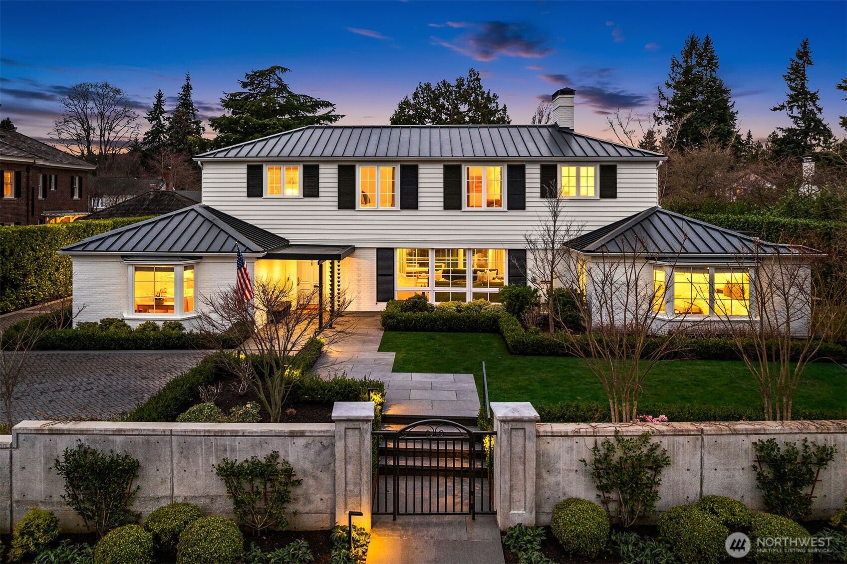 A rare opportunity in the coveted Broadmoor community. This 1940 residence by noted architect William Bain has undergone a masterful transformation, blending timeless architecture with today’s finest upgrades and Pasadena-style indoor-outdoor flow. Behind a private gated entry framed by lush new landscaping, the home offers true one-level living across an expansive main floor. East-facing, light-filled living and dining spaces flow seamlessly over oak hardwood floors to a professional-grade kitchen with Wolf range, Sub-Zero refrigerator, marble island, wine fridge, and walk-in pantry. Two main-level bedrooms include a serene primary suite with walk-in closet and elegant bath. Upstairs, a library landing wrapped in built-in bookshelves leads to two additional bedrooms connected by a Jack-and-Jill bath, one with a private balcony. The finished lower level offers a media room, wine room, laundry, and new bathroom. The main-level flows outside through a covered terrace with cedar ceiling, heaters, A/V,  DCS barbecue and outdoor kitchen overlooking the expansive lawn and fire pit. The adjacent 3-car garage and flex space, integrated via breezeway, provide a home office or guest suite with French doors to the lawn. Exhaustive infrastructure upgrades—new roof, siding, electrical, A/C, plumbing and sewer—ensure complete peace of mind and long-term value in this meticulously re-imagined Broadmoor estate.
